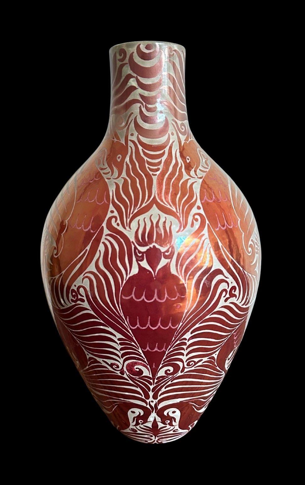 5395
Impressive, Large Jug by William De Morgan.
This exhibition quality piece is in a Ruby Lustre Glaze against a smokey ground and features 14 Mythical Birds in a Symmetrical design.
Firing cracks to the handle
42cm high and 22cm wide
Sands