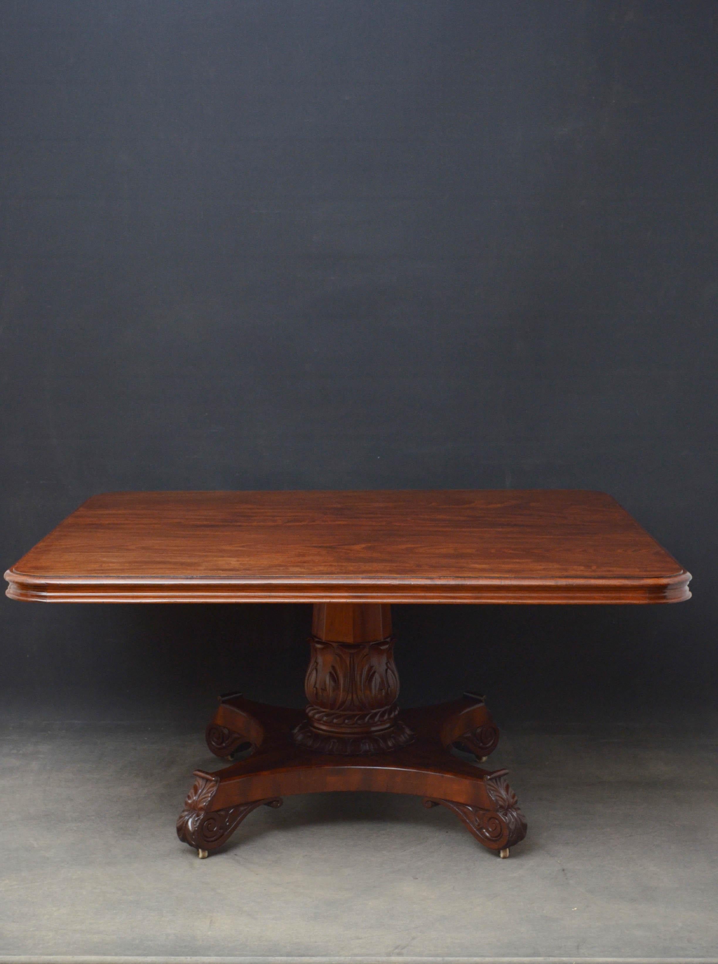 Sn4860, superb William IV mahogany dining or center table, having solid, figured mahogany tile top with moulded edge and shaped frieze above substantial, flat faceted column with acanthus leaf carved decoration and tulip carved collar terminating in