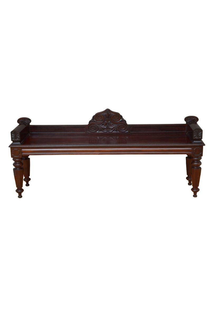 K0607  Superb William IV hall bench in mahogany, having panelled gallery to the back edge with S shaped scroll carving to the centre, solid mahogany seat with moulded edge and  finely carved ends above shaped front and side frieze, all standing on