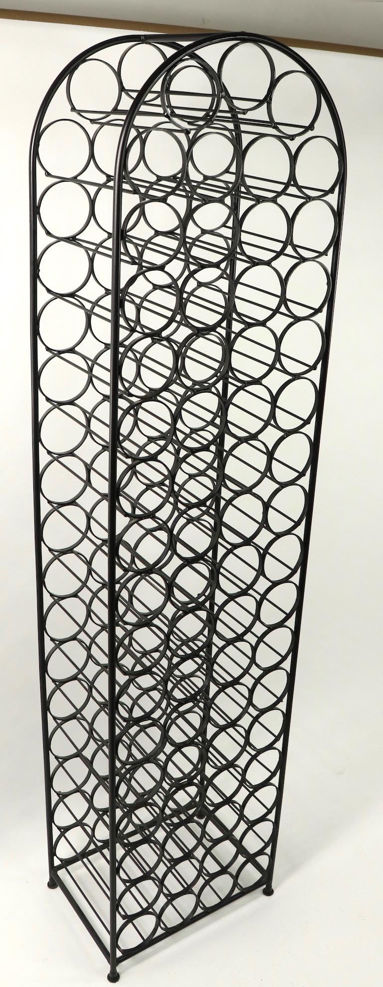 Large dome top wrought iron wine rack designed by Arthur Umanoff. The rack holds 67 bottles and stands an impressive 71 inches tall. Clean original and ready to use condition.