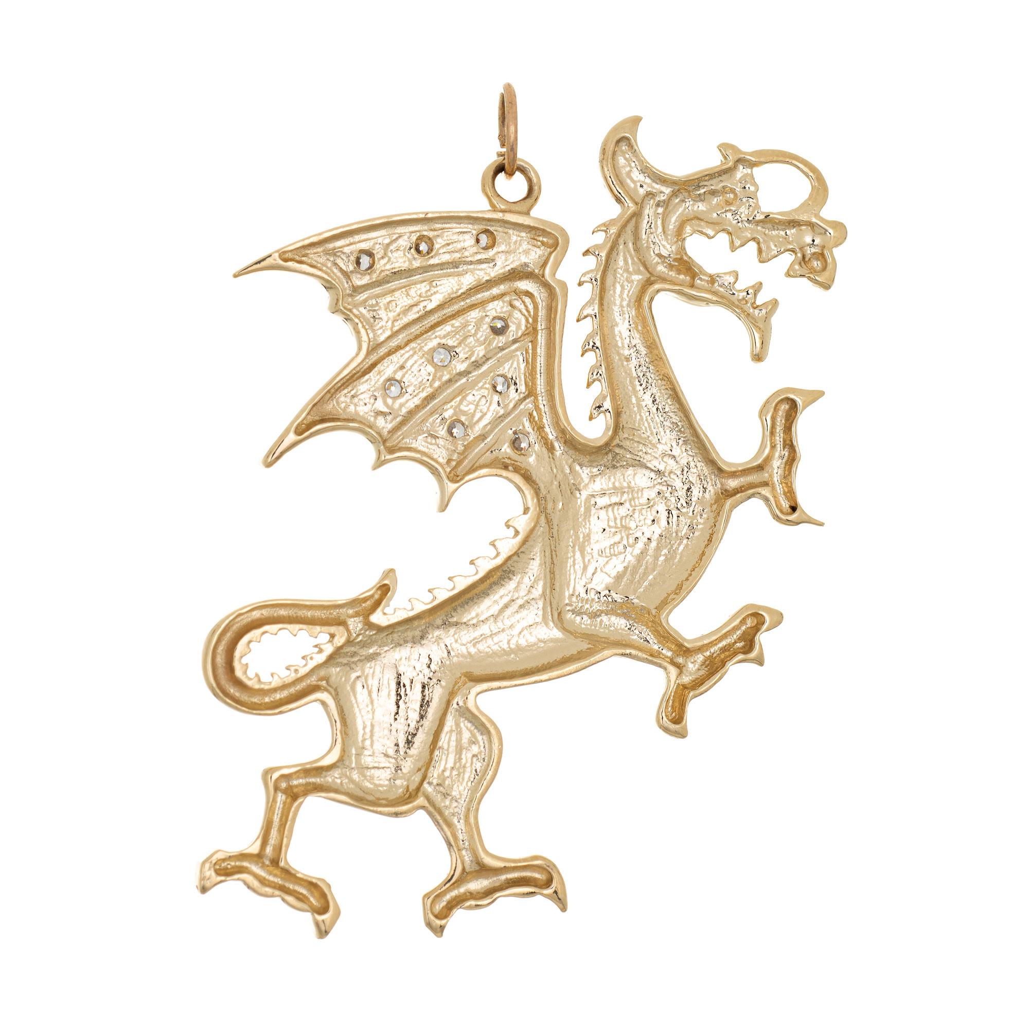 Finely detailed vintage winged dragon pendant crafted in 10 karat yellow gold (circa 1970s)

Diamonds total an estimated 0.05 carats (estimated at H-I color and SI1-2 clarity). 

The elaborate pendant highlights a diamond set winged dragon. Legend