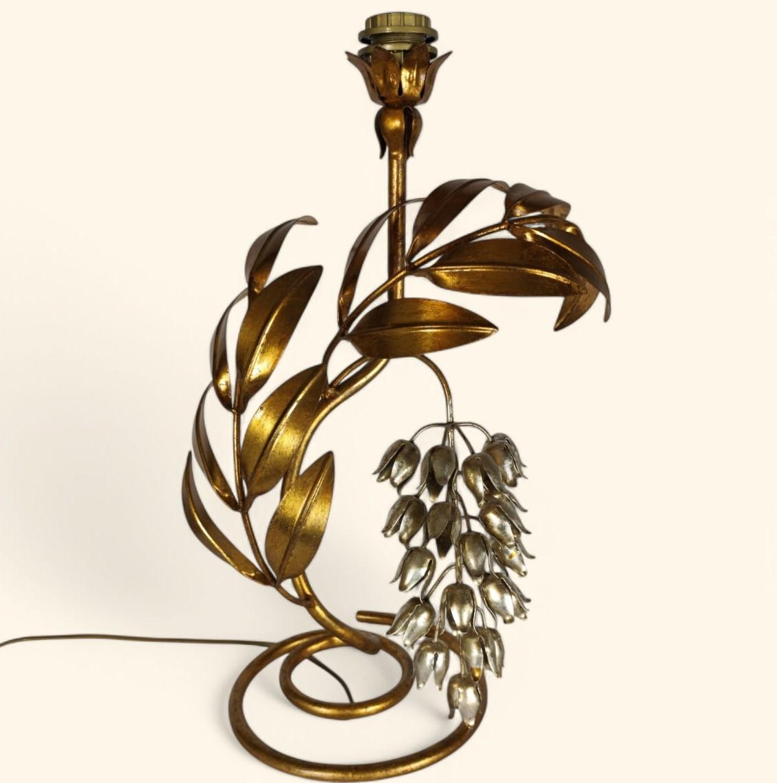 Large gilt and lacquered metal table lamp with a spray of silver-plated and lacquered wisteria flowers, by Hans Kögl.

Probably made by Maison Jansen in the 1960s and 1970s. 

The lamp is in very good condition and the wiring has been