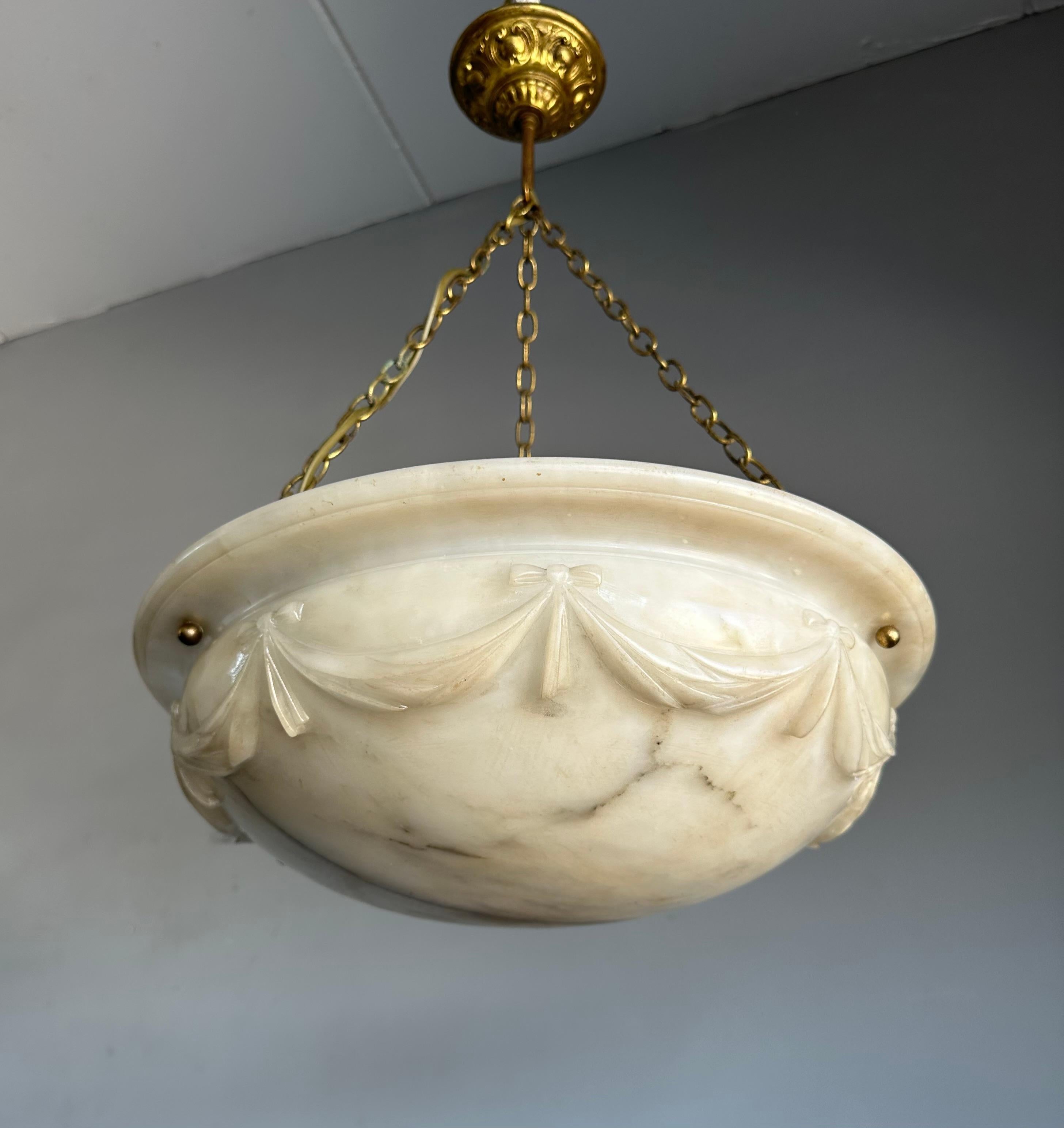 Arts and Crafts era chandelier with a rare carved shade.

Thanks to its large size, truly unique design and good condition this alabaster chandelier will light up both your days and evenings. It is all hand-crafted in the European Arts and Crafts