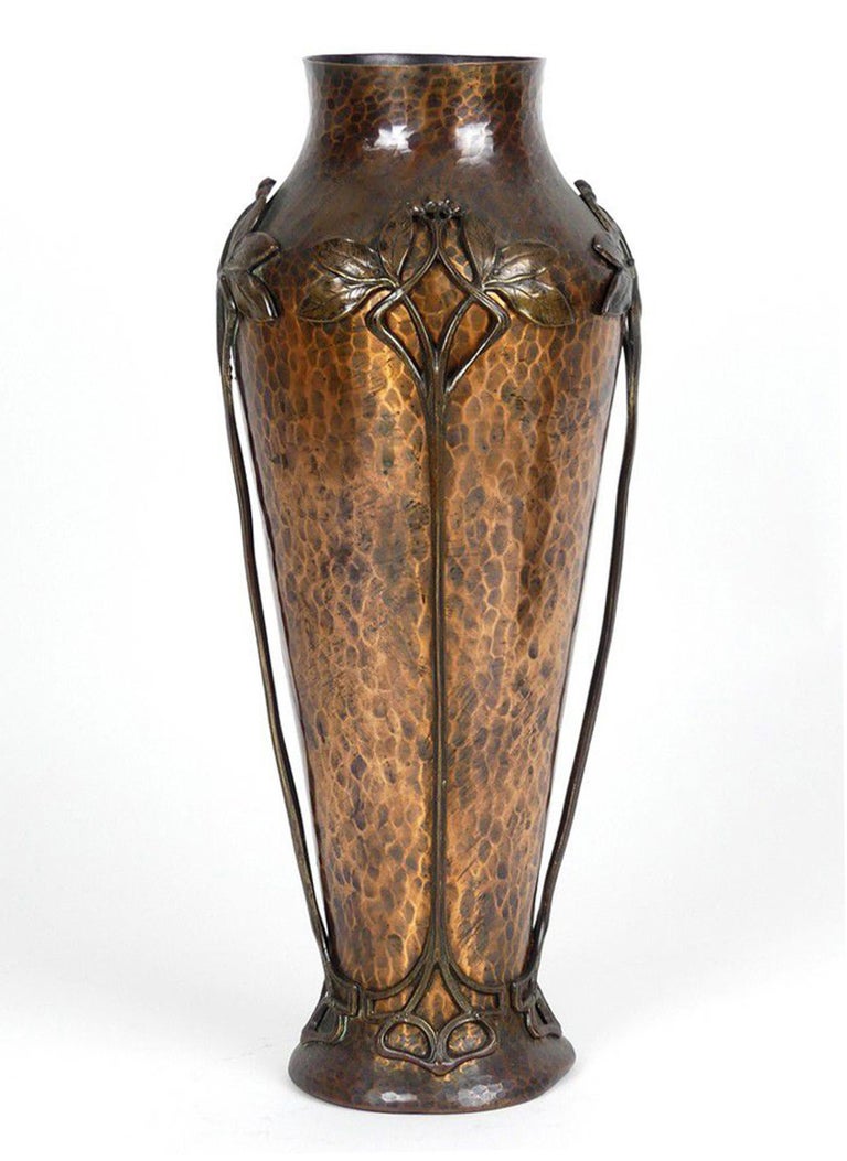 WMF Jugendstil copper vase, gingko floral style decoration shouldered tapering shape, hammer finish and overlaid with four patinated bronze stylized stems of gingko leaves and berries from the shoulder to the flaring foot. Height 15.25 inches.