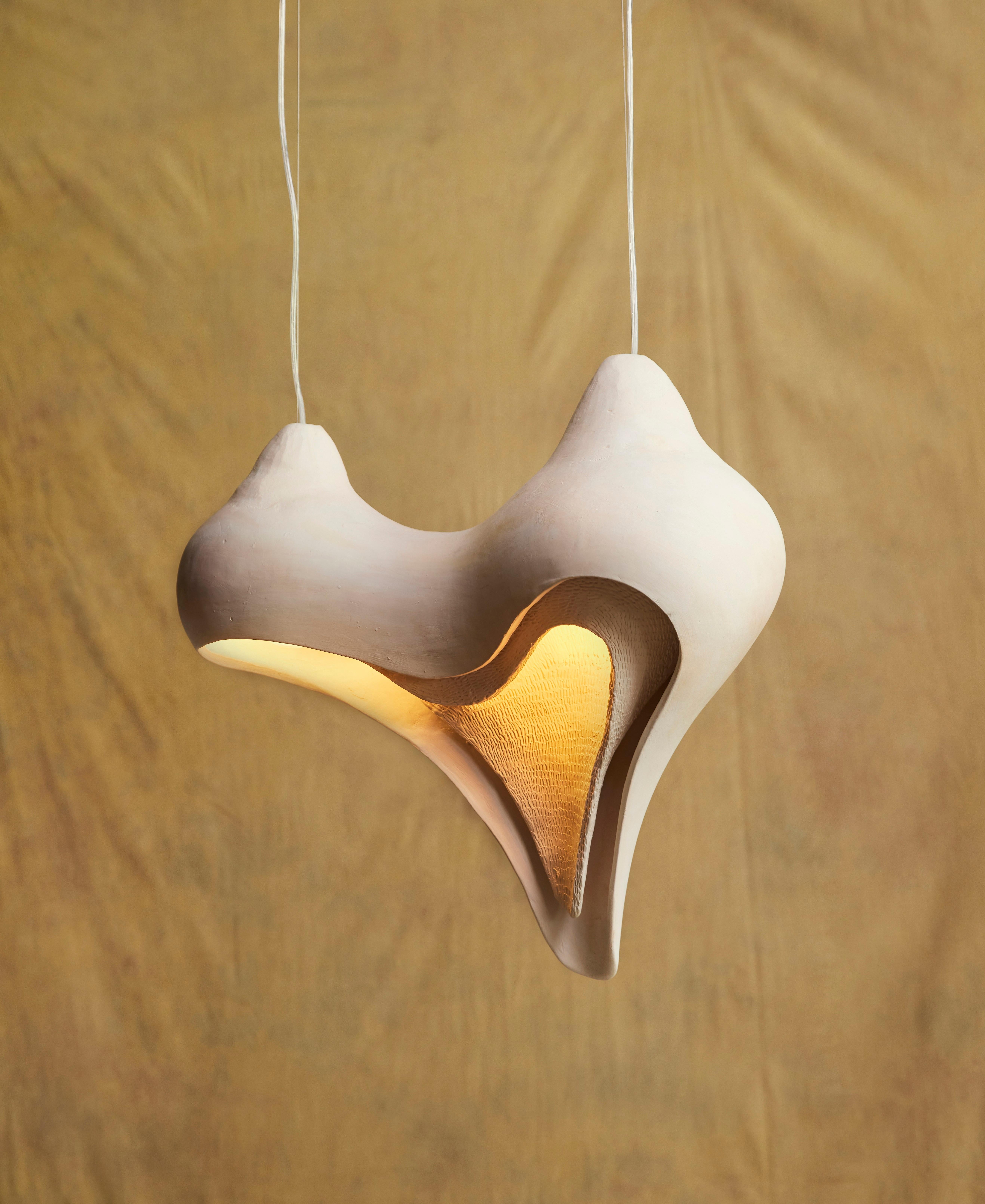 Large womb pendant lamp by Jan Ernst
Dimensions: D 28 W 60 H 55 cm
Materials: White stoneware


The Origin Collection is a collaboration between Jan Ernst and Colin Braye. The work translates the complexity and delicacy of biological and