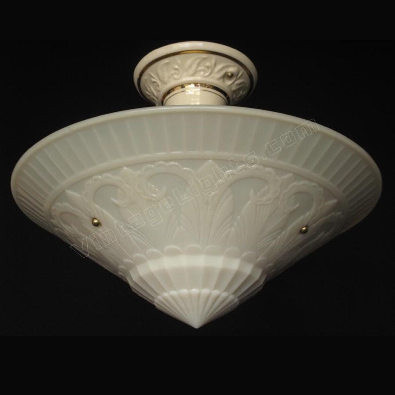 One of our favorite custard shades is this superbly detailed deco inspired floral pattern hanging shade. This antique lighting fixture is 15 1/2 inches wide, a compelling sight when lit. The custard glass has that 