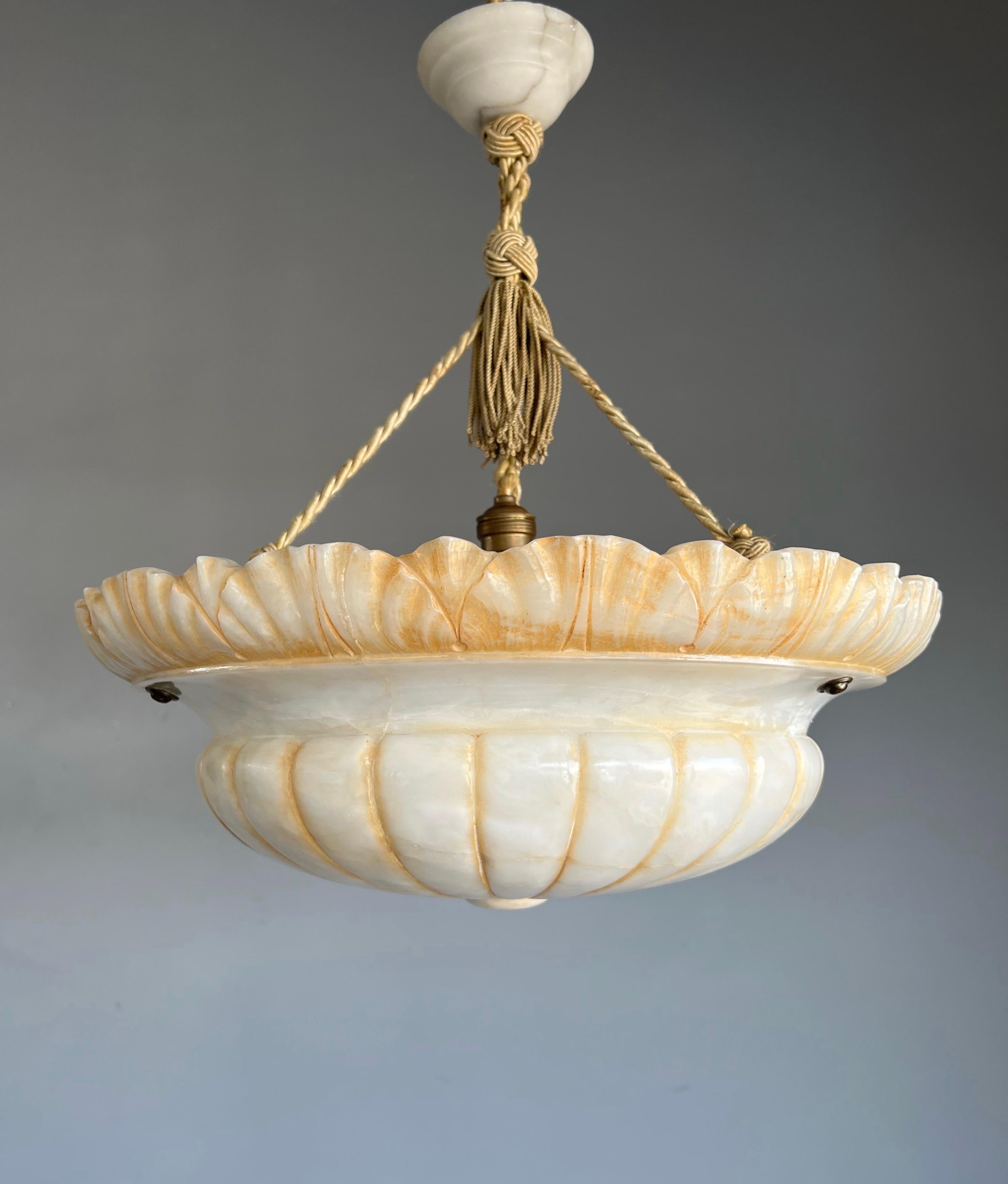 Large size and great design, hand carved, antique alabaster chandelier.

Thanks to its large size and unique design this antique and remarkable alabaster chandelier will be a real eyecatcher in your interior. Even with one very old repair to the