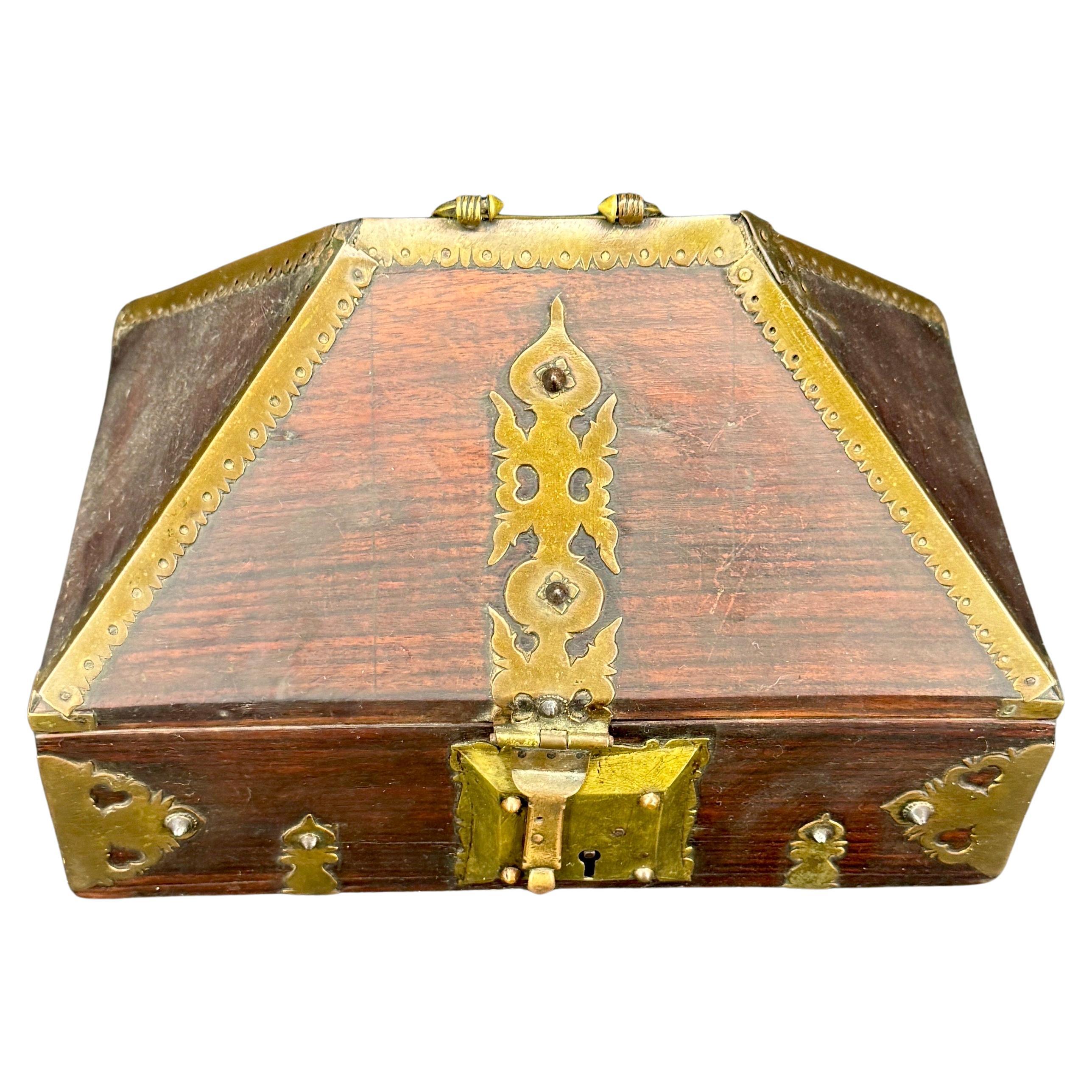 Impressive peaked hardwood dowry or jewelry box. This ornate piece features all brass hardware and is wood lined on the interior. Great functional piece or use or display.
