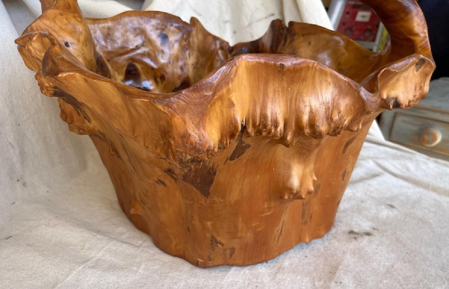 This large root or burl wood basket has an amazing patina and surface. The condition is very good and sturdy.