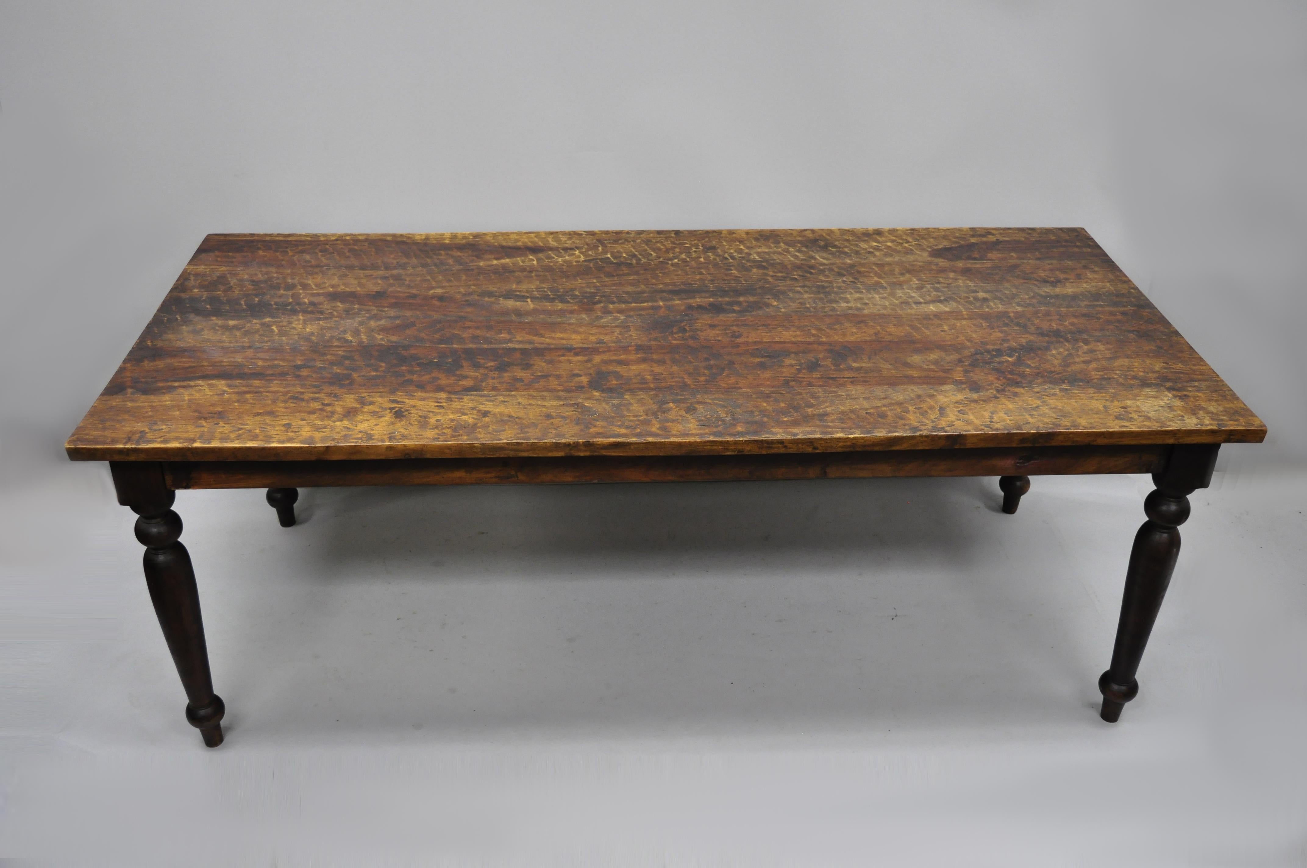 Large wood French style dining farm house table with turn carved legs. Item features turn carved legs, large impressive form, rippled/antiqued finish to top, solid heavy wood construction, beautiful wood grain, great style and form, circa 21st