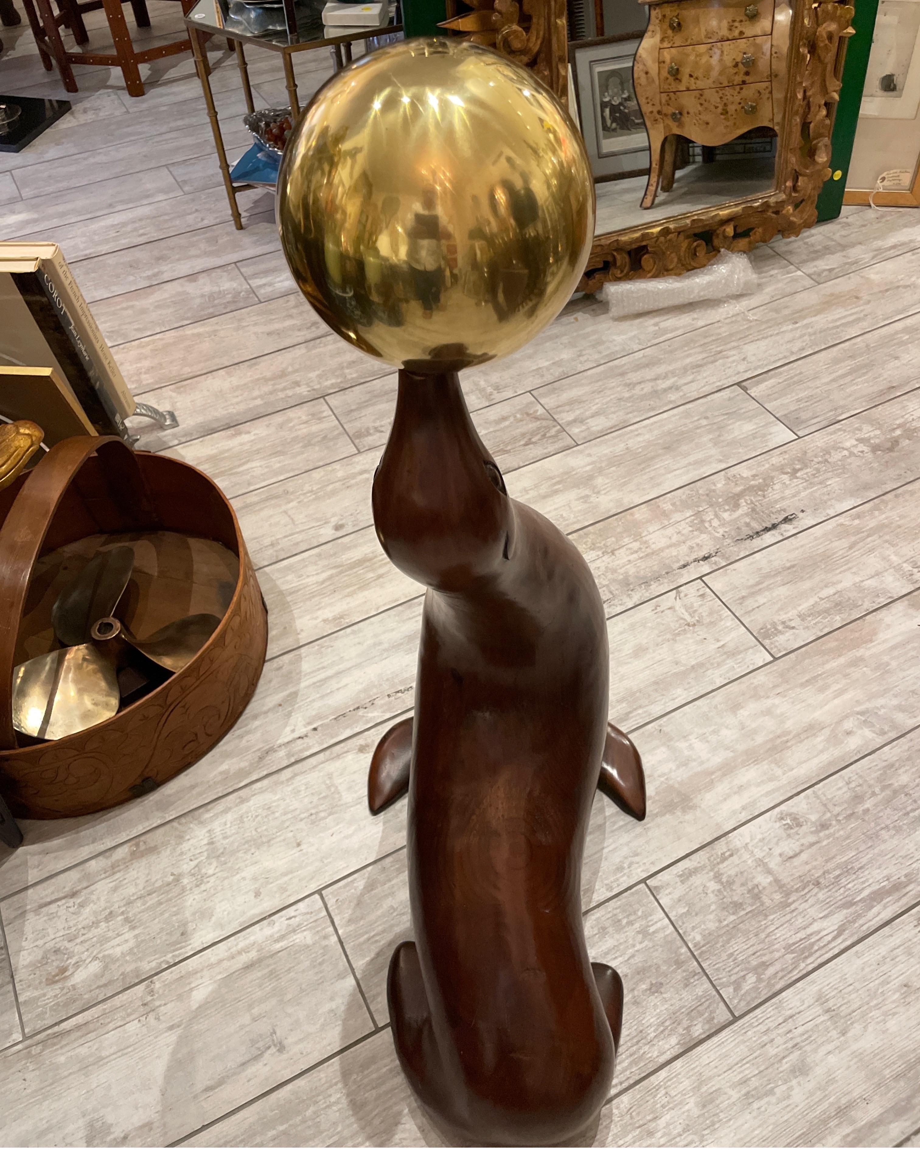 Large Wood Sculpture of a Seal Balancing a Brass Ball In Good Condition For Sale In West Palm Beach, FL