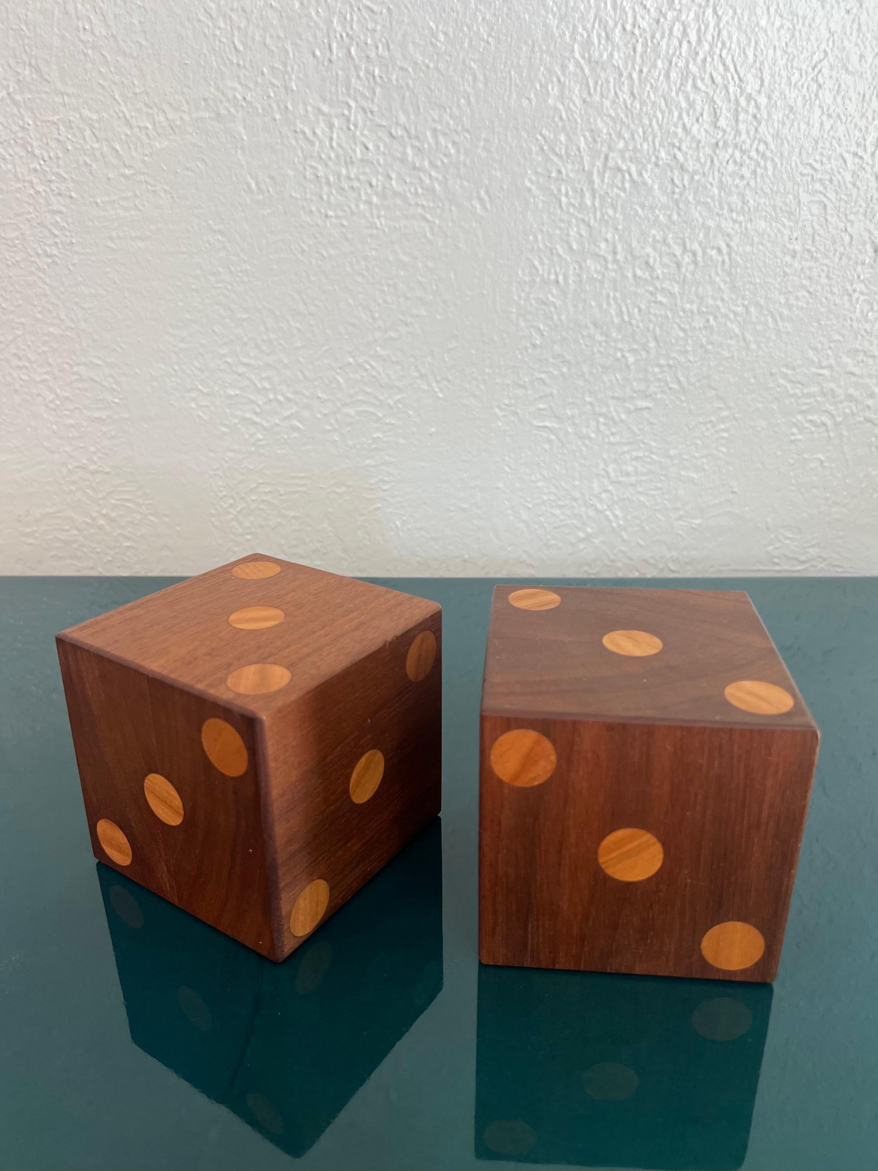 Large pair of wooden dice. All sides show a 3. Show some signs of wear (please refer to photos). 

Would work well in a variety of interiors such as modern, mid century modern, Hollywood regency, etc. Piece blends seamlessly with other designers