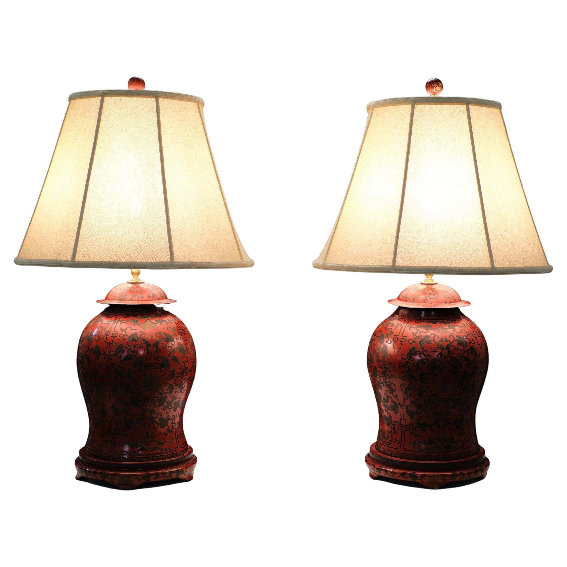 Stunning set of large Wooden Chinese table lamps . 
Classic Red and Black , formed and proportioned  temple jars wired as lamps.
Hand carved Flower motif comes with beautiful original hand made shade .
One large E27 bulb needed each. Switch on the