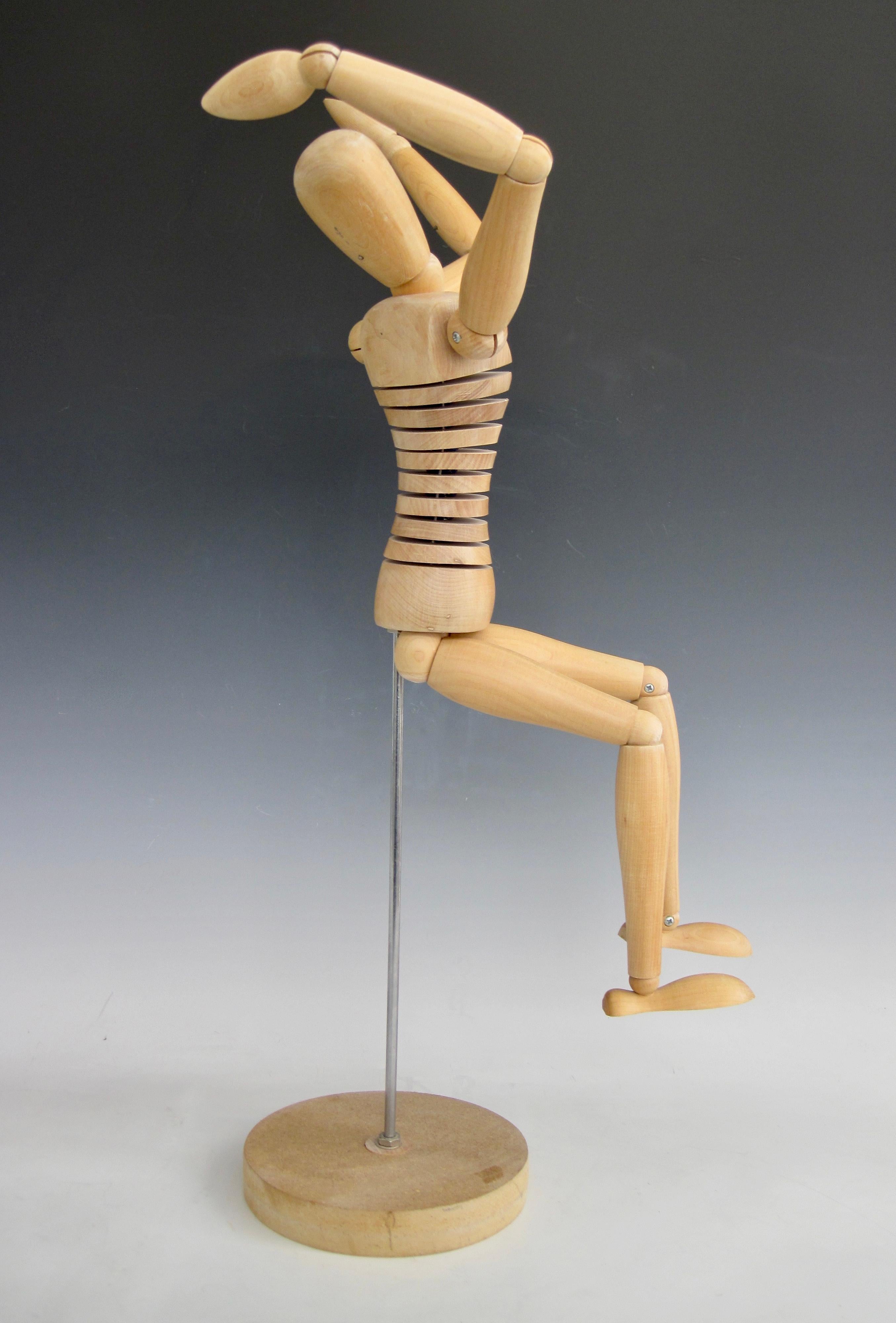 A statuesque wooden human figure artist mannequin standing at 25.5