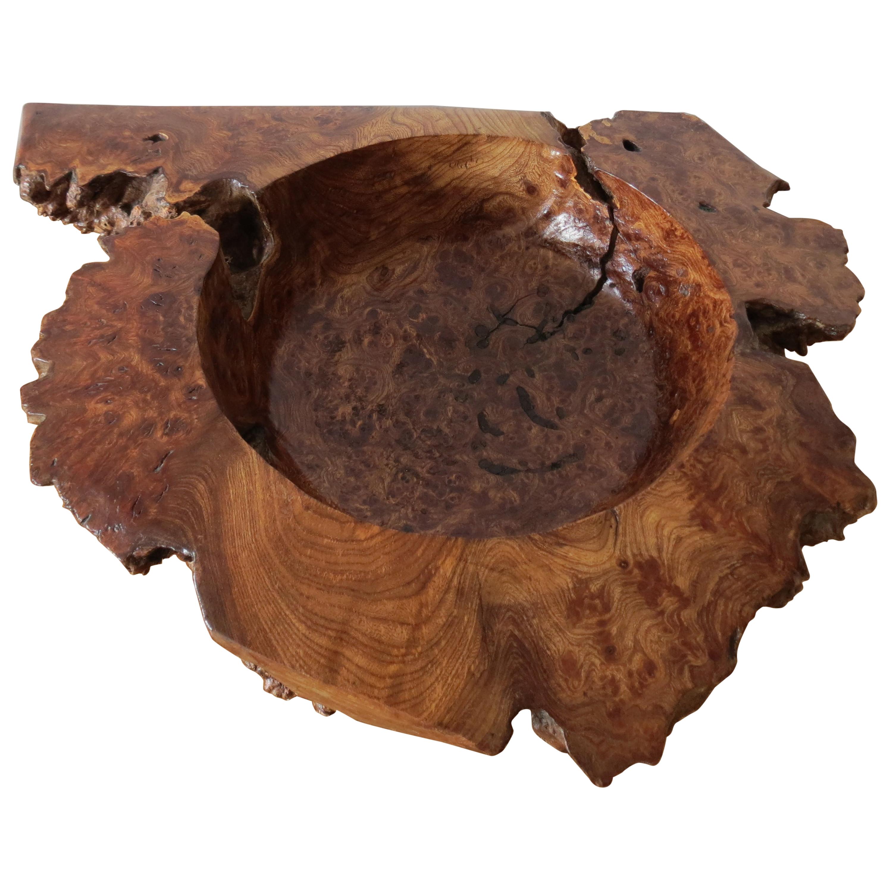 A large wooden bowl, hand produced from Welsh Burr Elm. Very nice details figurative grain and a wonderful color. Hand produced with a rough hand-turned bowl to the center. Good over all condition, some ageing and surface cracks to the wood created