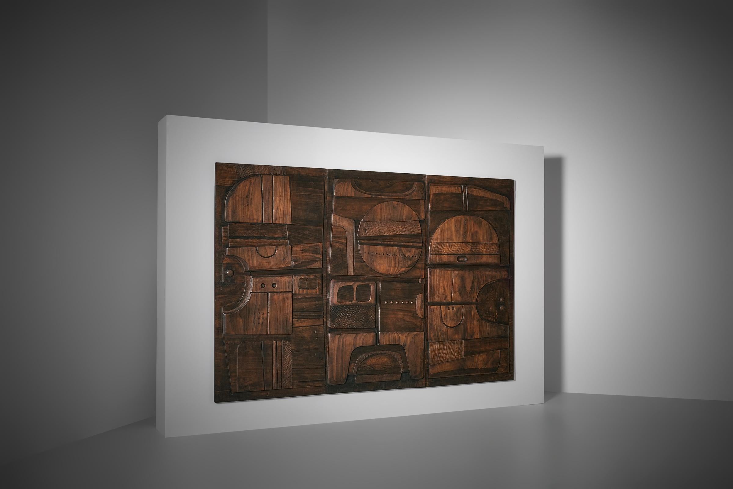 Large wooden sculptural triptych by Nerone Ceccarelli, Italy ca. 1978. Unique wall relief showing a variety of carved organic and free-form geometric shapes arranged into a harmonious composition. Observing the work, the large circle positioned at