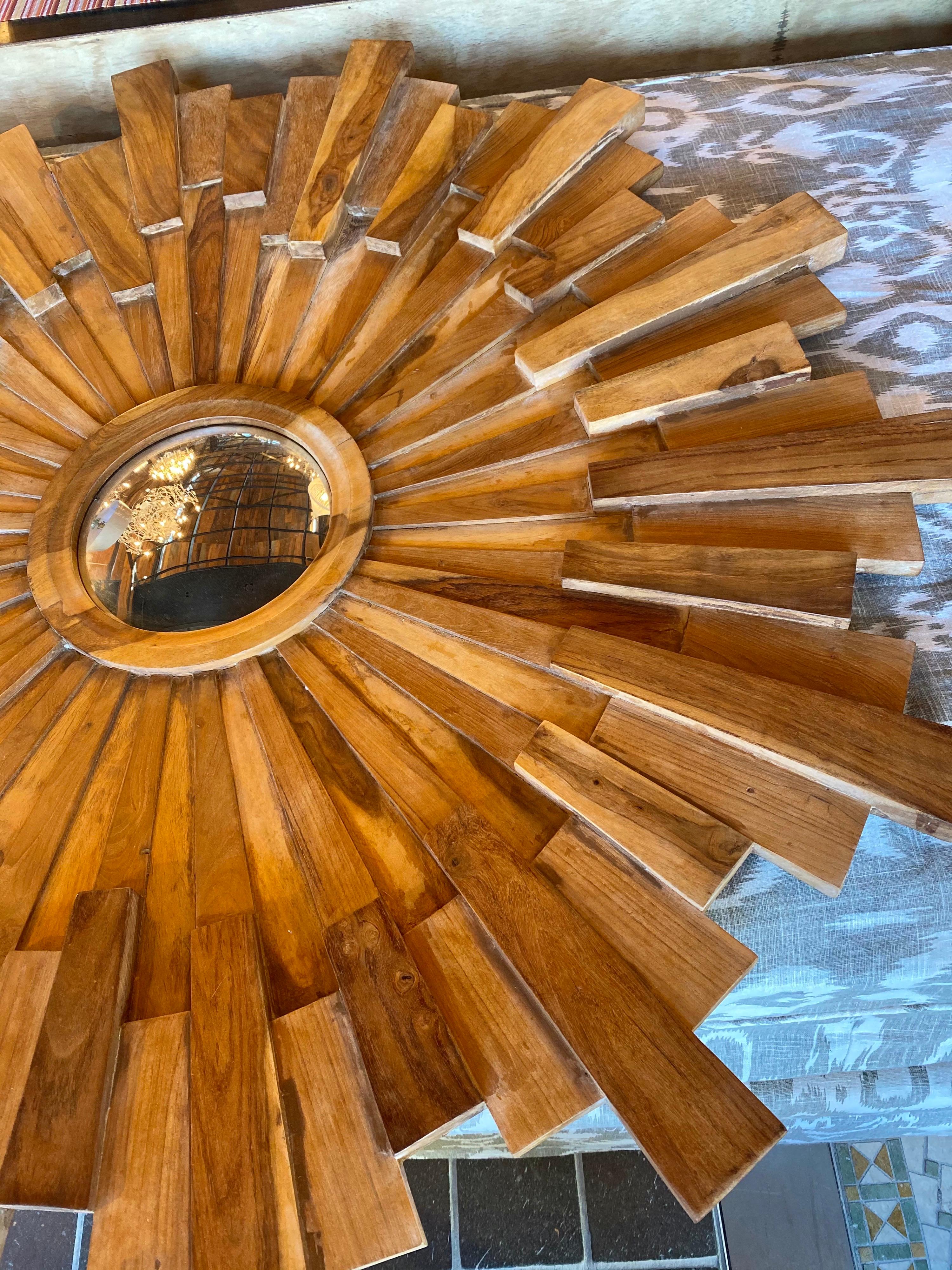 Large wooden starburst mirror

Measures: 47