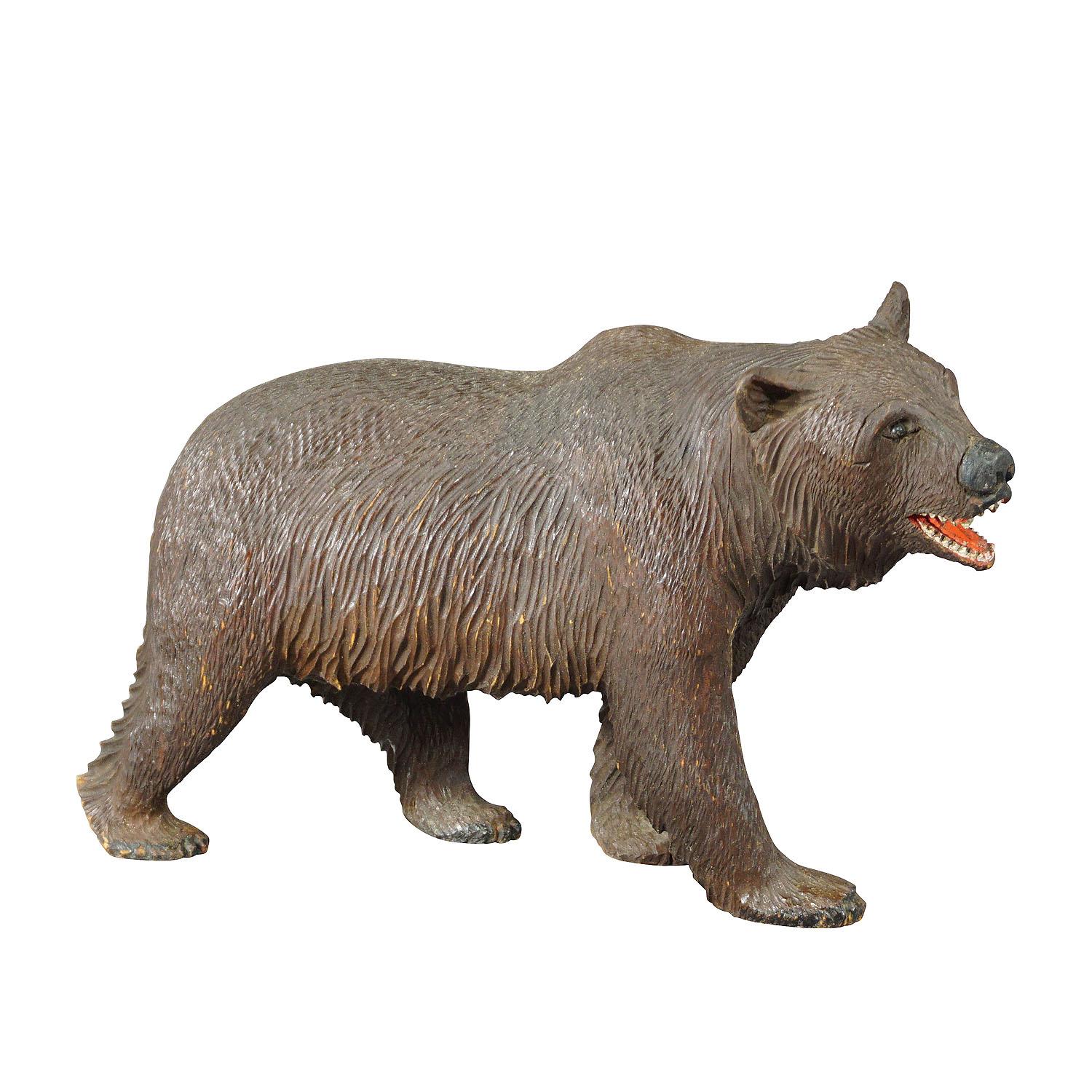 Large Wooden strolling bear handcarved in Brienz ca. 1930

A large antique statue of a walking bear. Made of lindenwood, finely handcarved with naturalistic details in Brienz, Switzerland ca. 1930. A nice example of the famous Black Forest