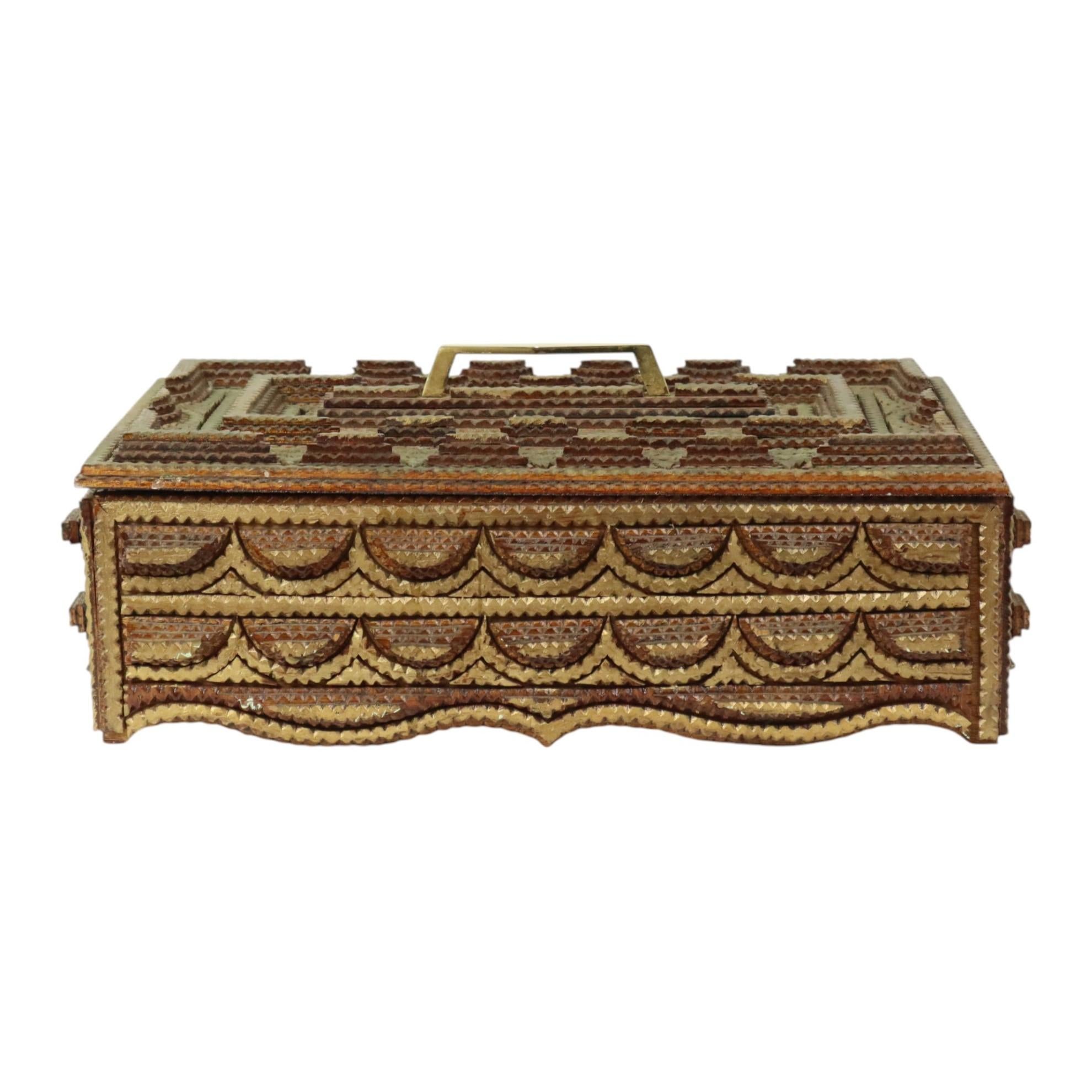 Large tramp art box with lid and brass handle, folk art object made of layered pieces of gold, partly gold colored, from the late first half of the 20th century.

Beautiful form of folk art, anyone could make a tramp art object with what they had on