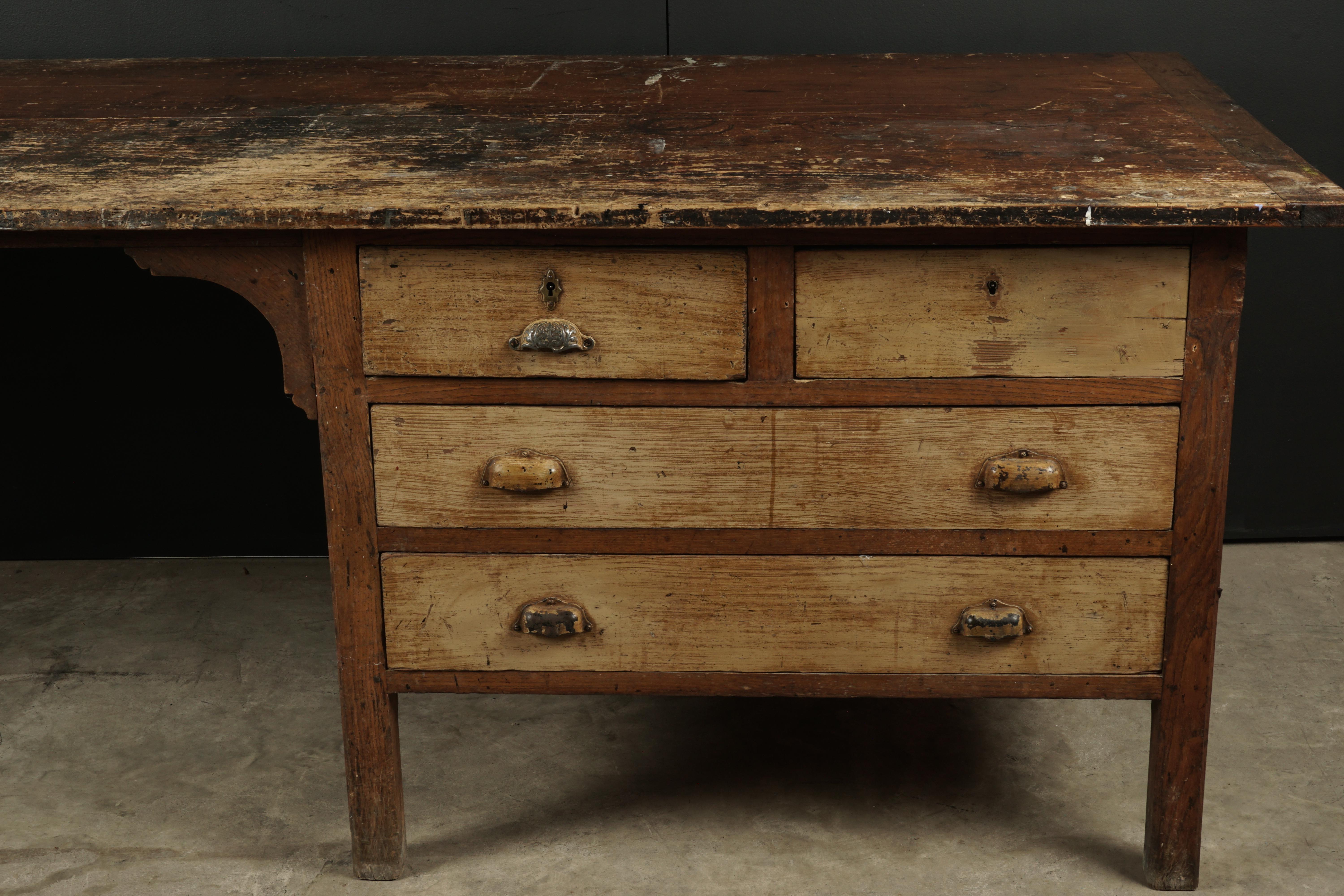 Large work console from France, circa 1940. Solid pine construction with four drawers. Nice original surface with patina.