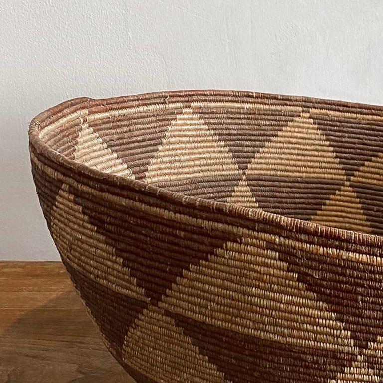 A rare large early basket with bands of triangle decoration.
Probably Hambukushu people Botswana, Africa. 1940s.
Measures: 27cm H x 48cm W.
