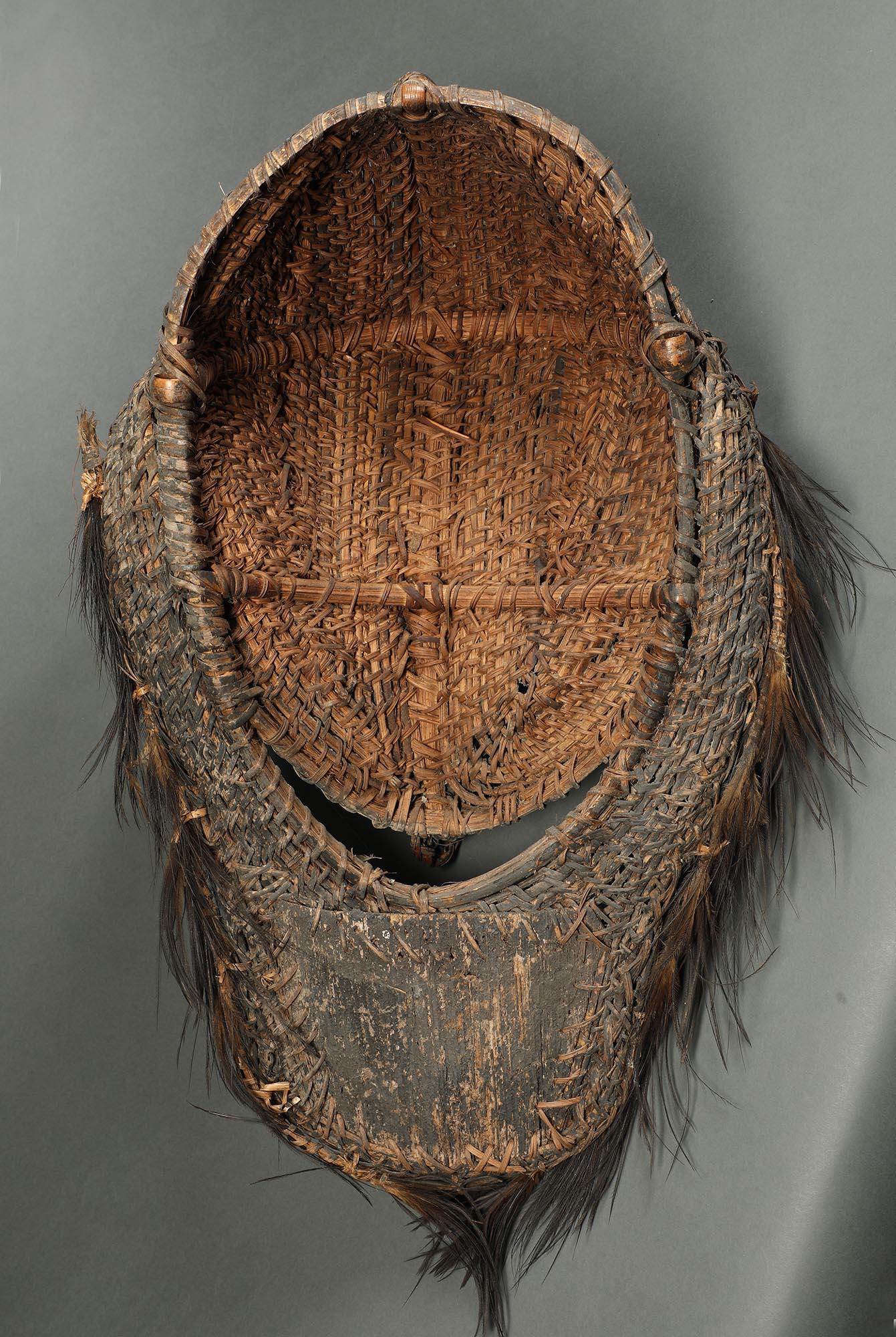 Large woven painted basketry wall mask Blackwater rivers area, Papua New Guinea. With open expressive mouth and mask fringed with feathers, striking mask that easily hangs on the wall. 24 inches high, mid 20th century.