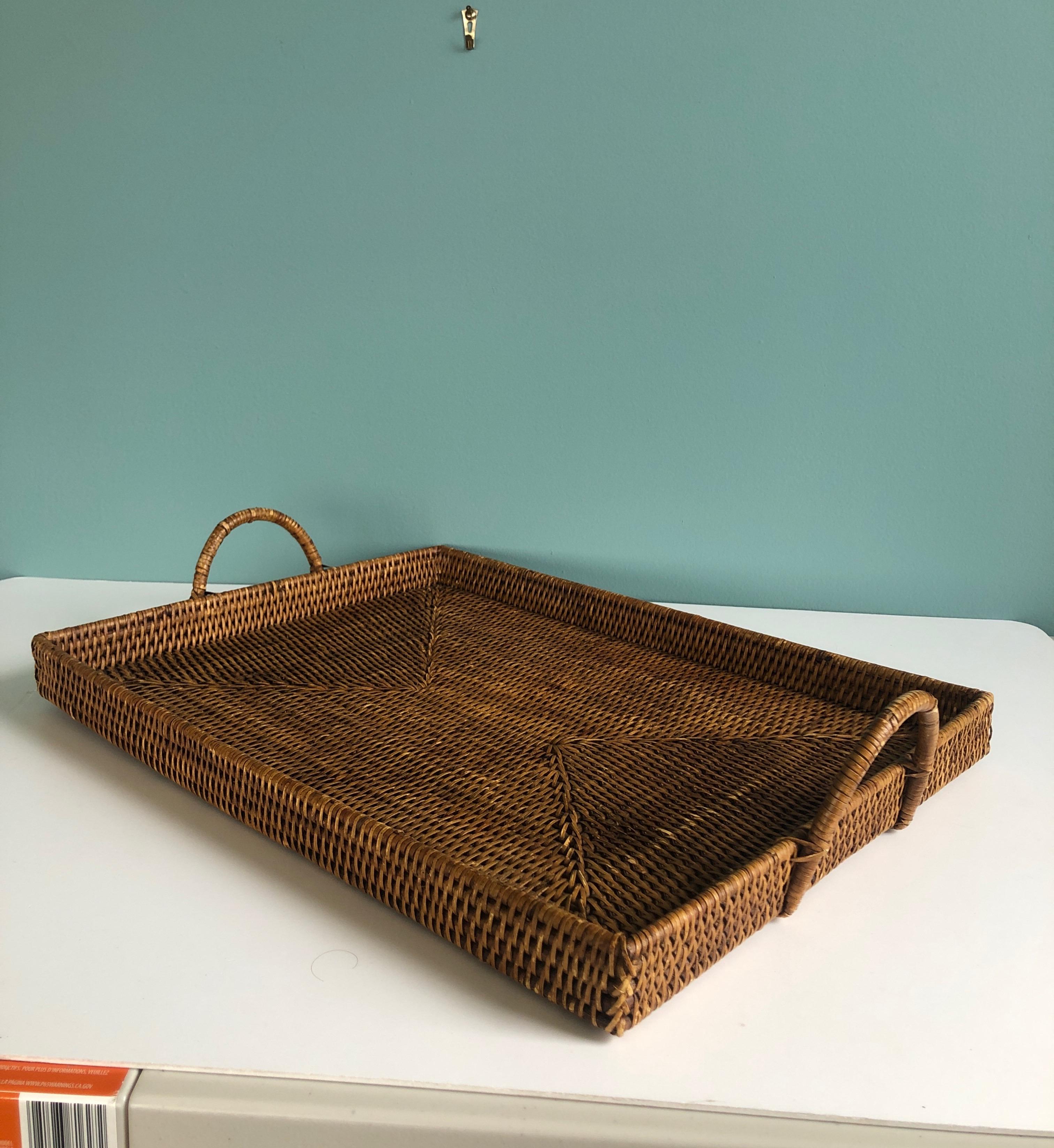 Large woven rattan serving tray with handles
Measures: 1.5” W x 14.75” D x 4” H. (to top of handle).
 