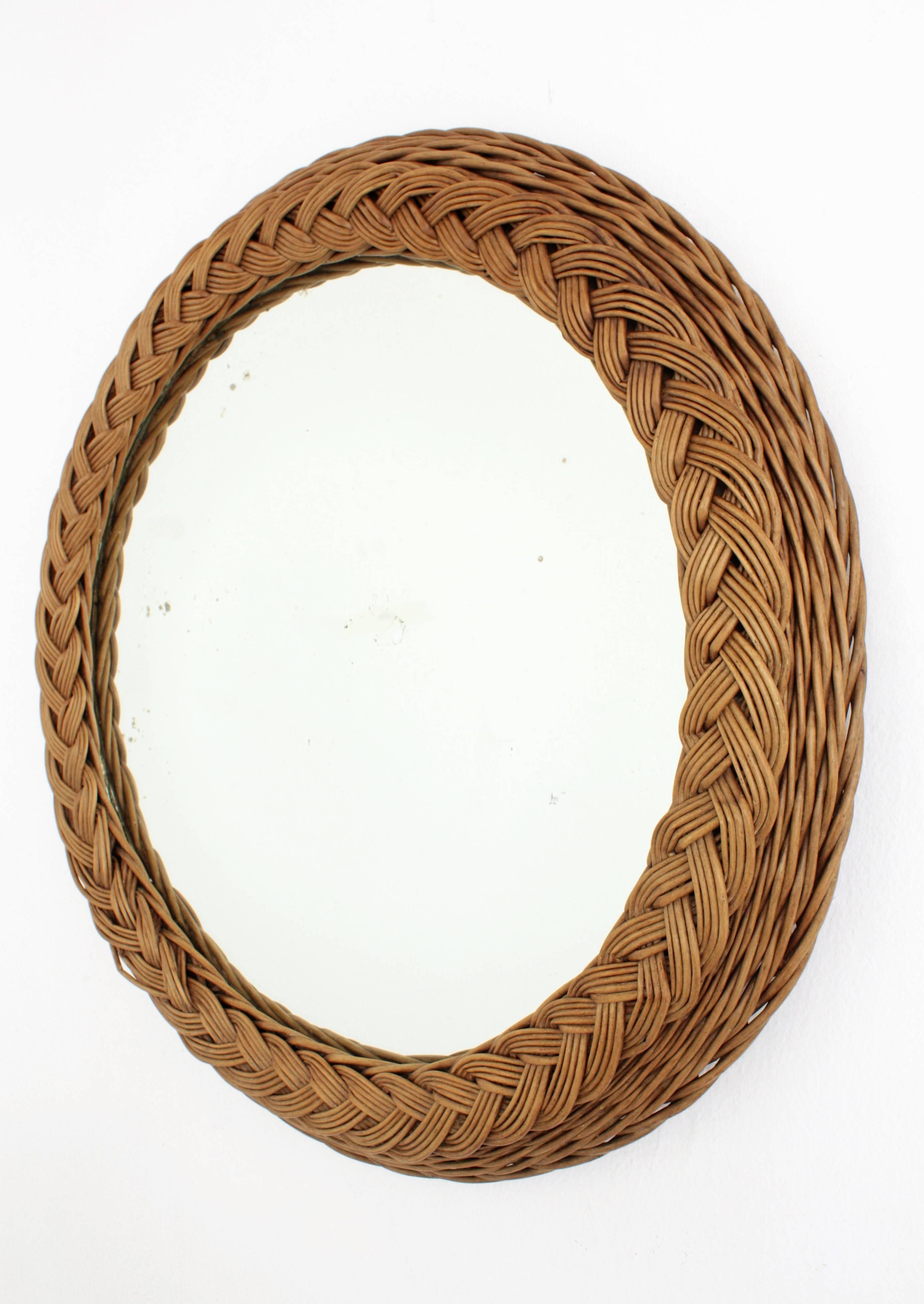 A beautiful large size handwoven wicker mirror with a braided frame . Unusual in this size. Handcrafted in Spain, circa 1940s.
Lovely to place alone but also interesting to create a wall composition with other wicker, rattan or bamboo