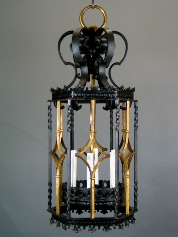This wrought and pierced iron lantern has gilt accents. The ornate scrolls are enhanced by the gilt work. Six light.
Needs rewiring