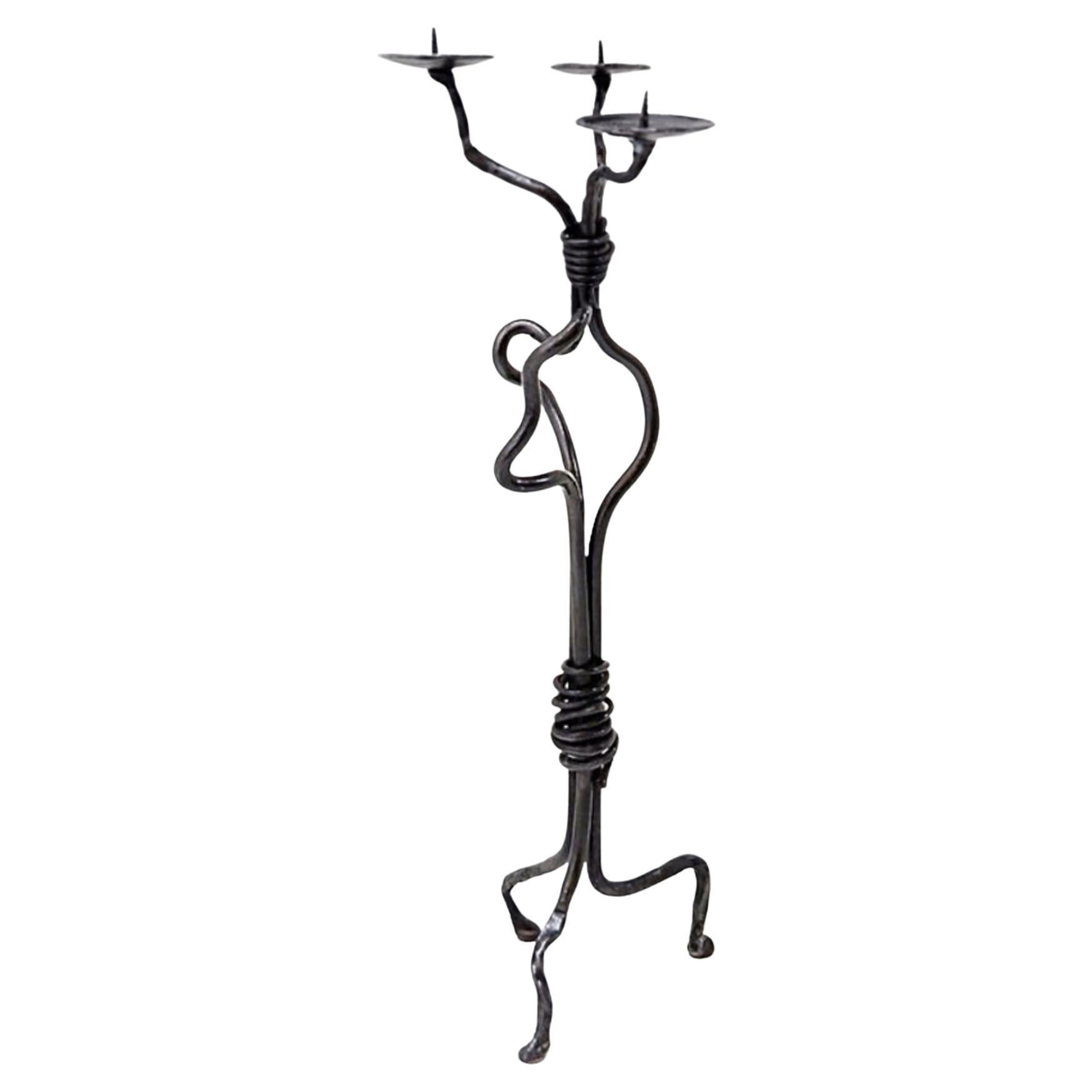 Large wrought iron candelabra with an abstract design and three candle holders