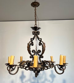 Large wrought iron chandelier with 8 arms and decorated with gilt iron palmettes