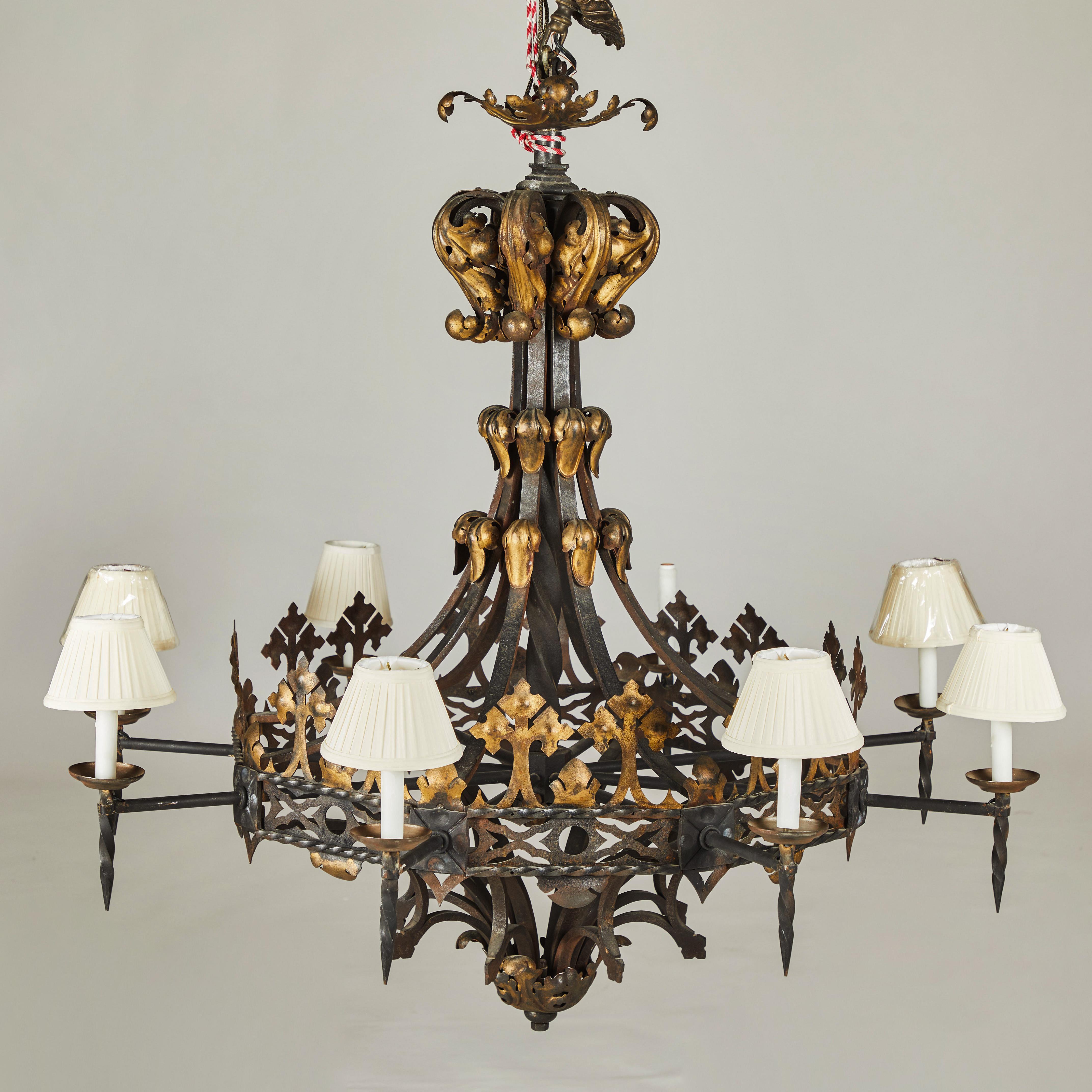 Gorgeous, large wrought iron and gilt decorated chandelier.
Elegantly sloped neck adorned with delicate gilded leaves. Eight arms terminate in torchiere style candle holders,
Late 19th century.
Origin: France
Originally purchased at Sotheby’s London