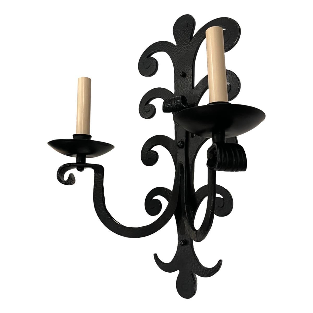 Set of four French circa 1900 large wrought iron two-arm sconces.

Measurements:
Height: 19.5