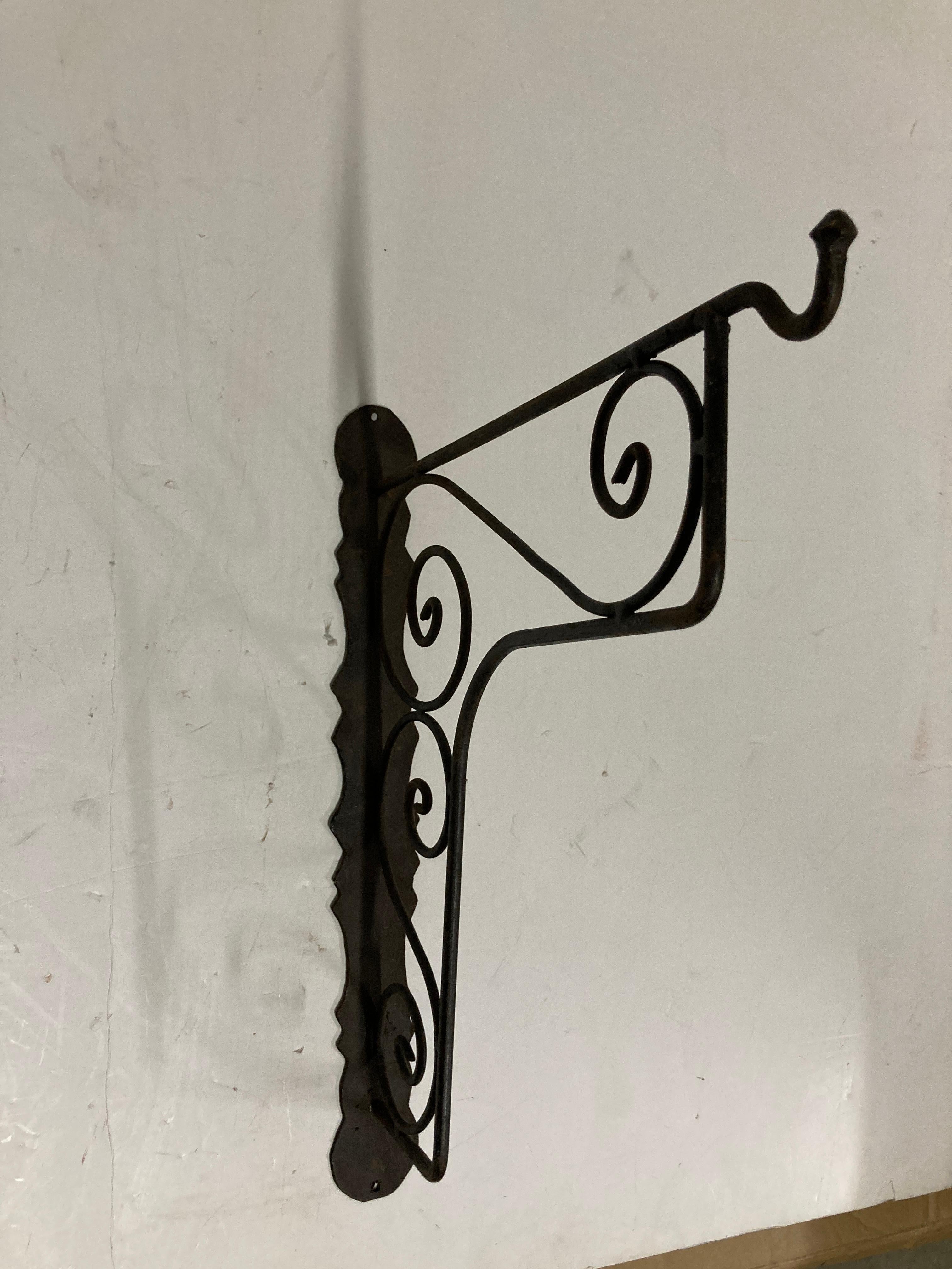 Large hand crafted iron scroll design wall bracket. 
Wrought iron handcrafted wall-bracket for lanterns or signs.
Perfect for hanging lights or plants outdoors.
Scrolling wall-mounted brackets.
Multiple available.
Dimensions: Projection: 15.25
