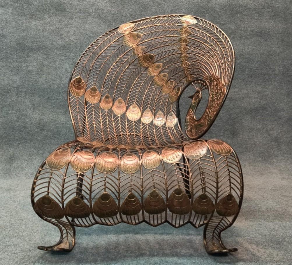 Stunning and rare, this heavy wrought iron peacock chair is more sculpture than seating. Intricate pattern of splines and peacock 