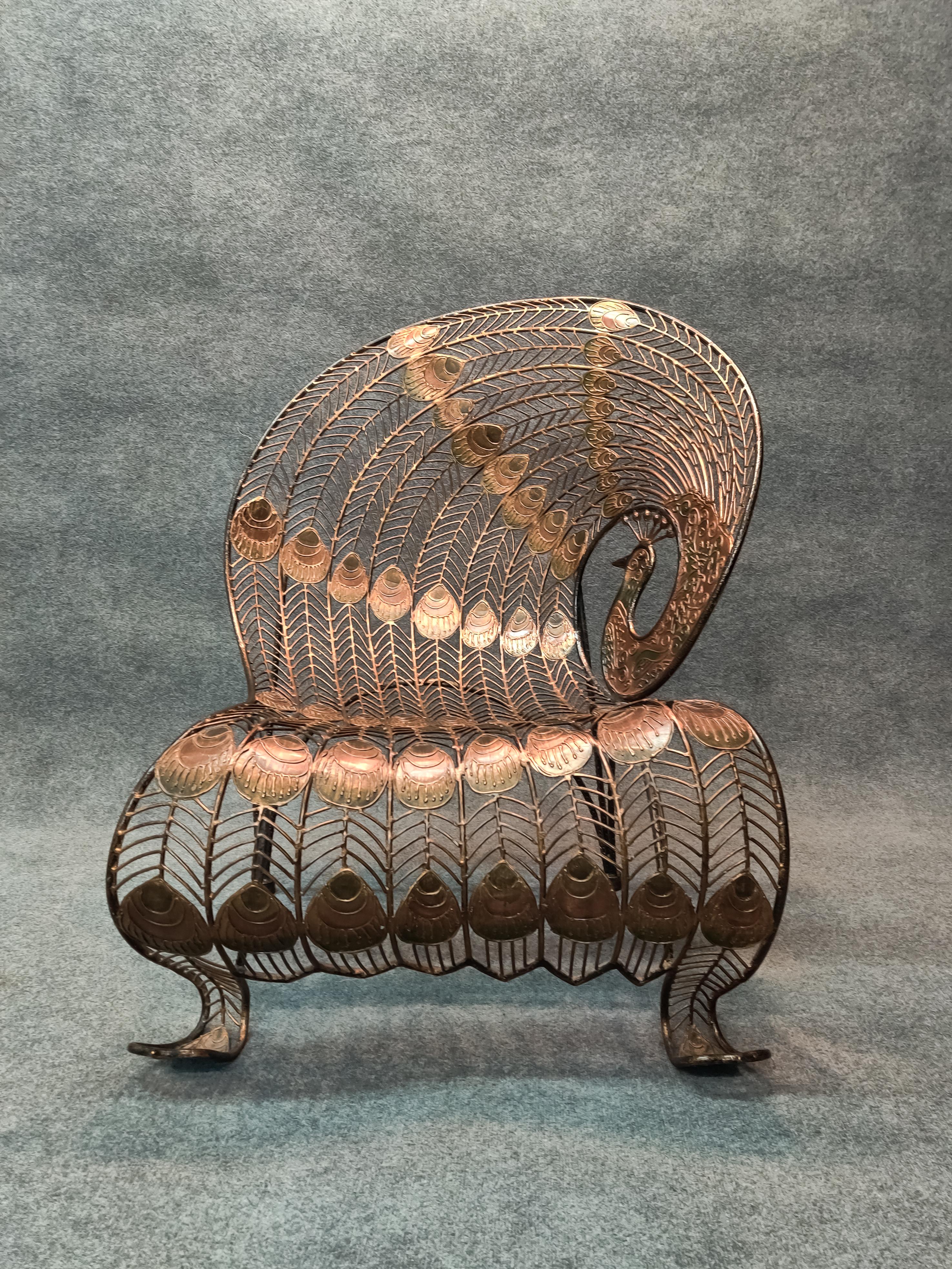 Stunning and rare, this heavy wrought iron peacock chair is more sculpture than seating. Intricate pattern of splines and peacock 