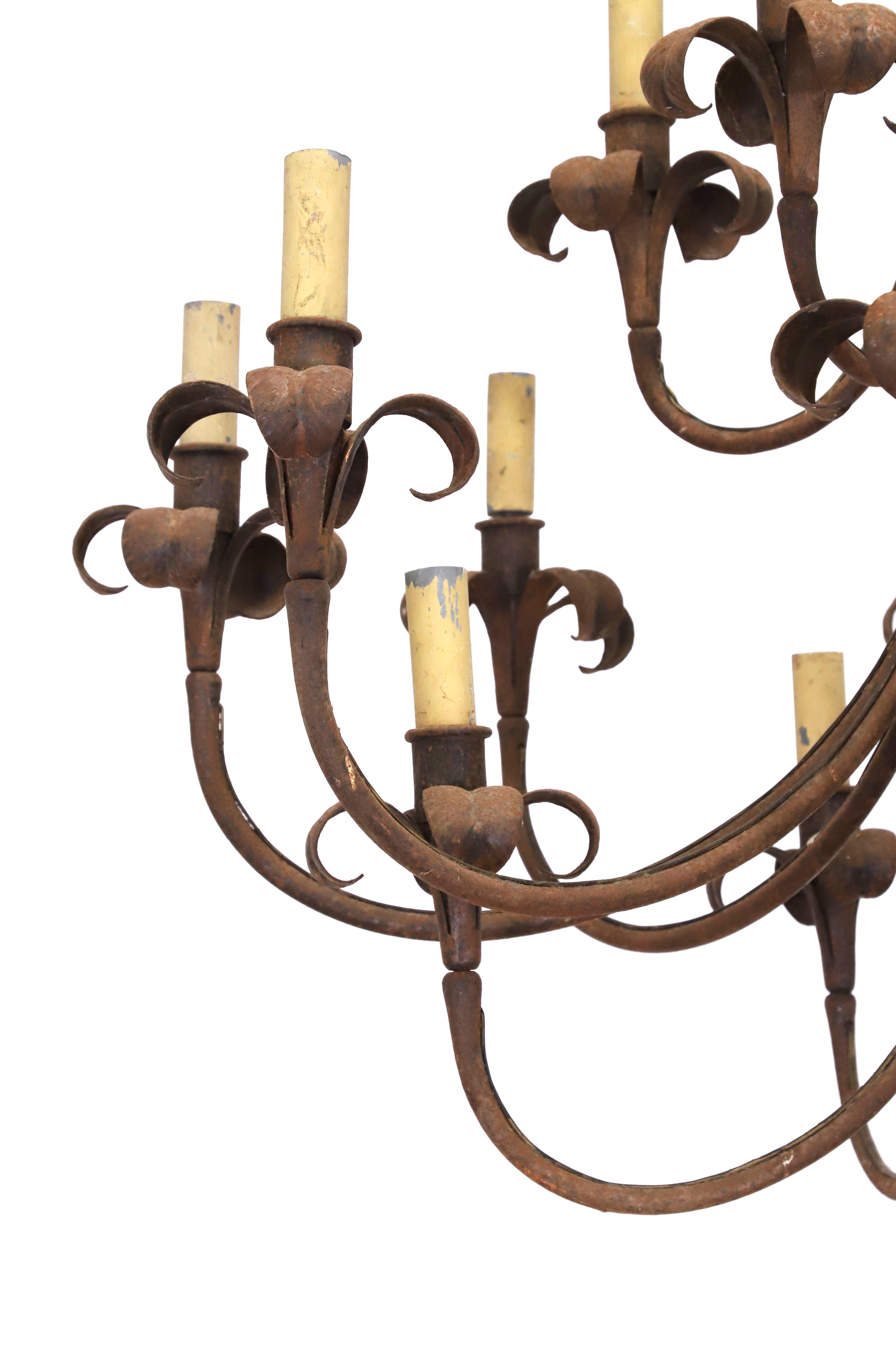 A large wrought iron sixteen-light chandelier
20th Century, with petalled branches.

90cm diameter
95cm high

Provenance: Wolterton Hall, Norfolk, England.

Will require re-wiring.