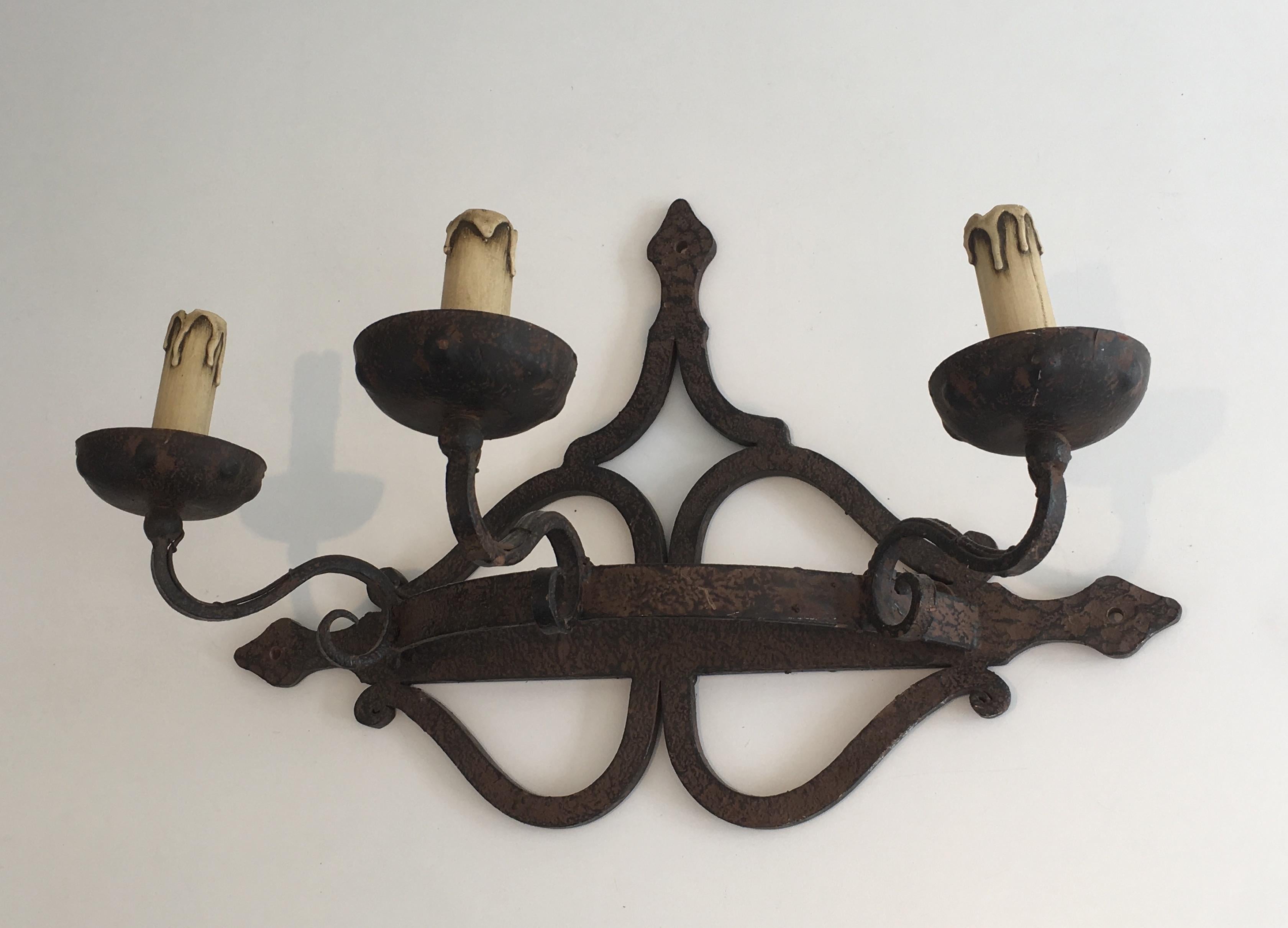 This decorative single large wall light is made of wrought iron. This is a French work, circa 1950.