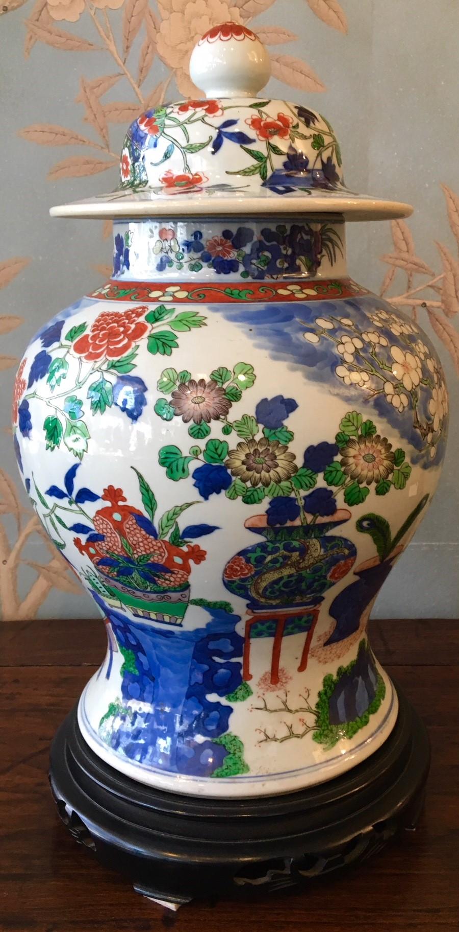 A very large 18th-early 19th century Wucai (five color) temple jar with vibrant glaze, and design of vases, pomegranates and flowers. Double ring marking at base. 18 inches high when sitting on base.