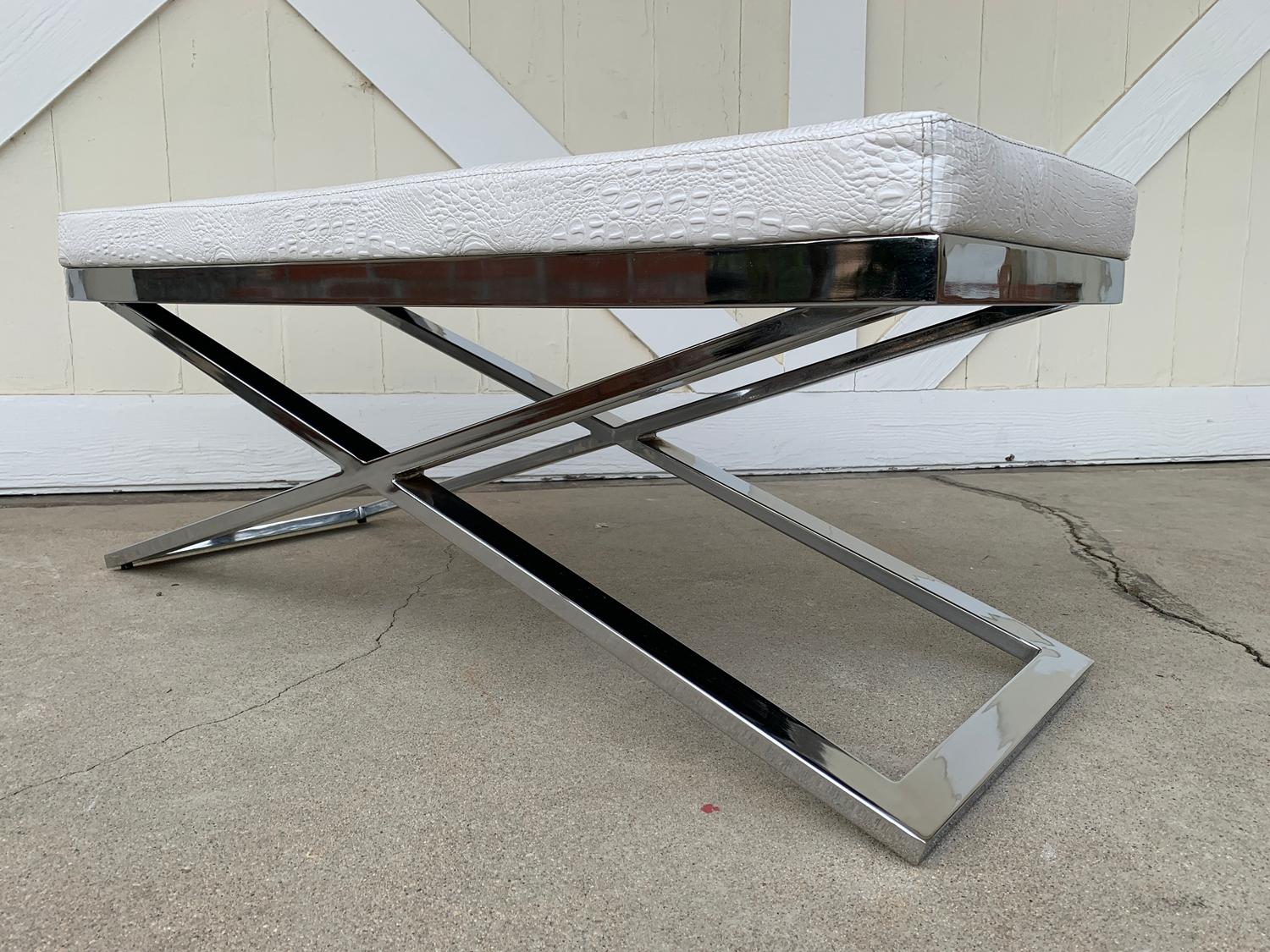 Beautiful and large bench having a chrome X frame base and upholstered in a faux crocodile Naugahyde.
The piece is in very good condition with only minor surface marks to the metal and the upholstery.

Measurements:
43.25 inches wide x 17.50