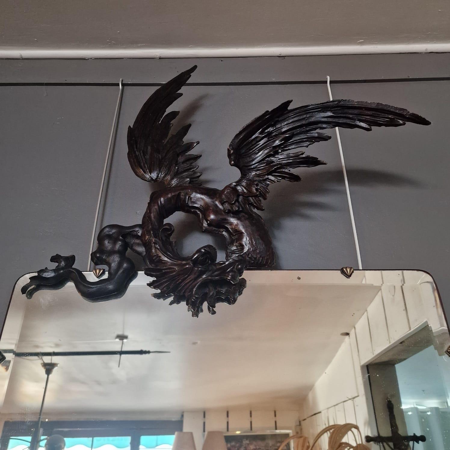 Very large wooden late XIXth century « dragon » mirror in the style of Gabriel Viardot.
Beveled mirror, brass rings on the sides.
Very decorative piece in good condition. 