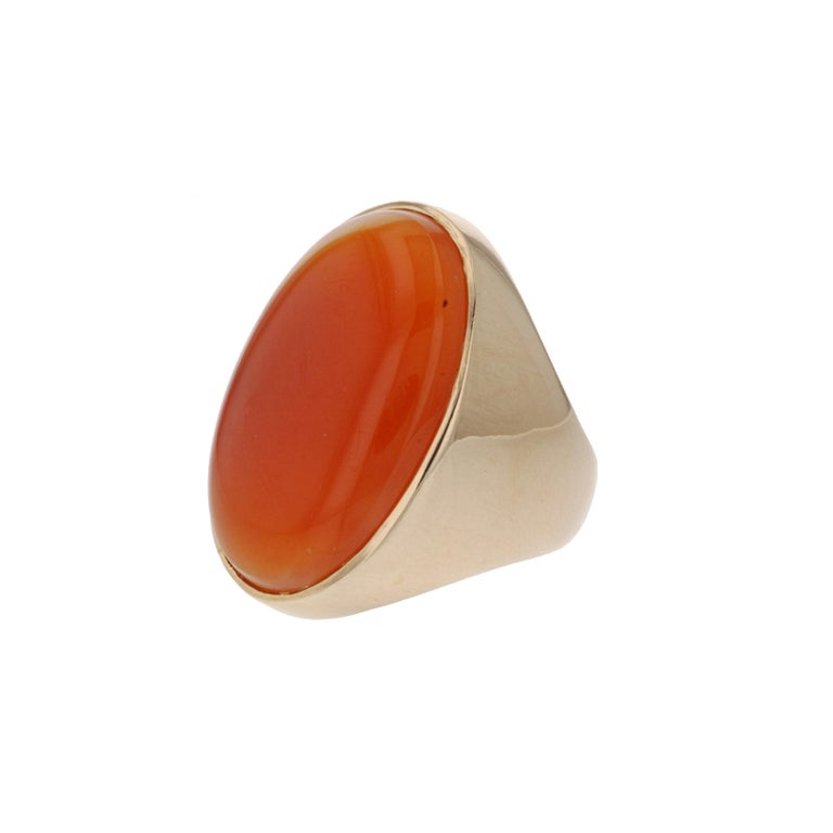 14K yellow gold ring featuring a large oval cabochon Carnelian.  Simple and smooth but large enough to make a statement.  Ring measures 1-1/4