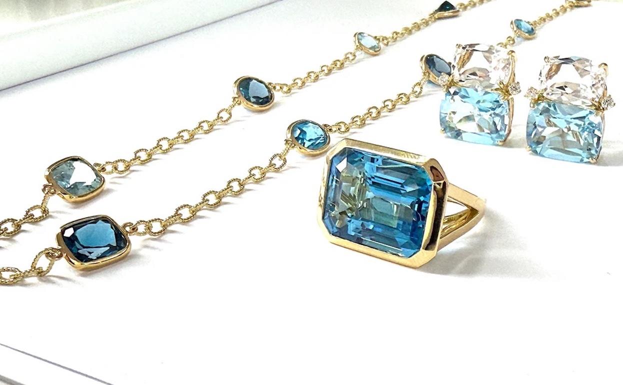 Une véritable pièce d'apparat ! 

Bague contemporaine sur mesure en or jaune 18kt sertie d'un chaton en forme d'émeraude et dotée d'une élégante tige fendue.

La topaze bleue, taillée en émeraude, est magnifiquement proportionnée et mise en valeur