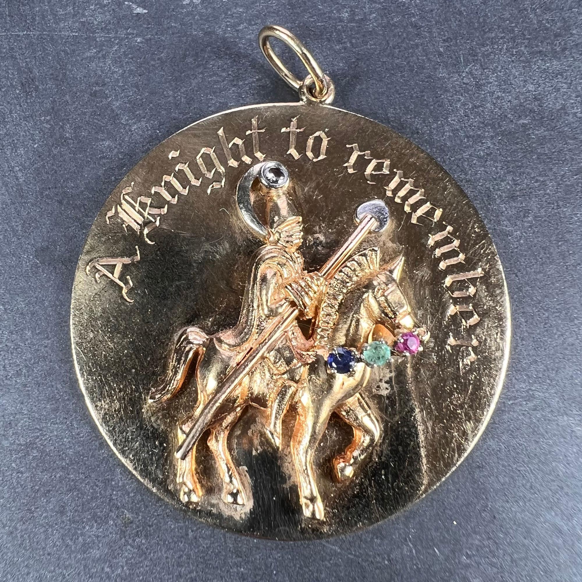 A very large 14 karat yellow gold charm pendant designed as a gem set round medallion depicting a knight on horseback in relief, engraved 'A Knight To Remember'. The knight carries a spear with white gold heart shaped tip, and has a white diamond