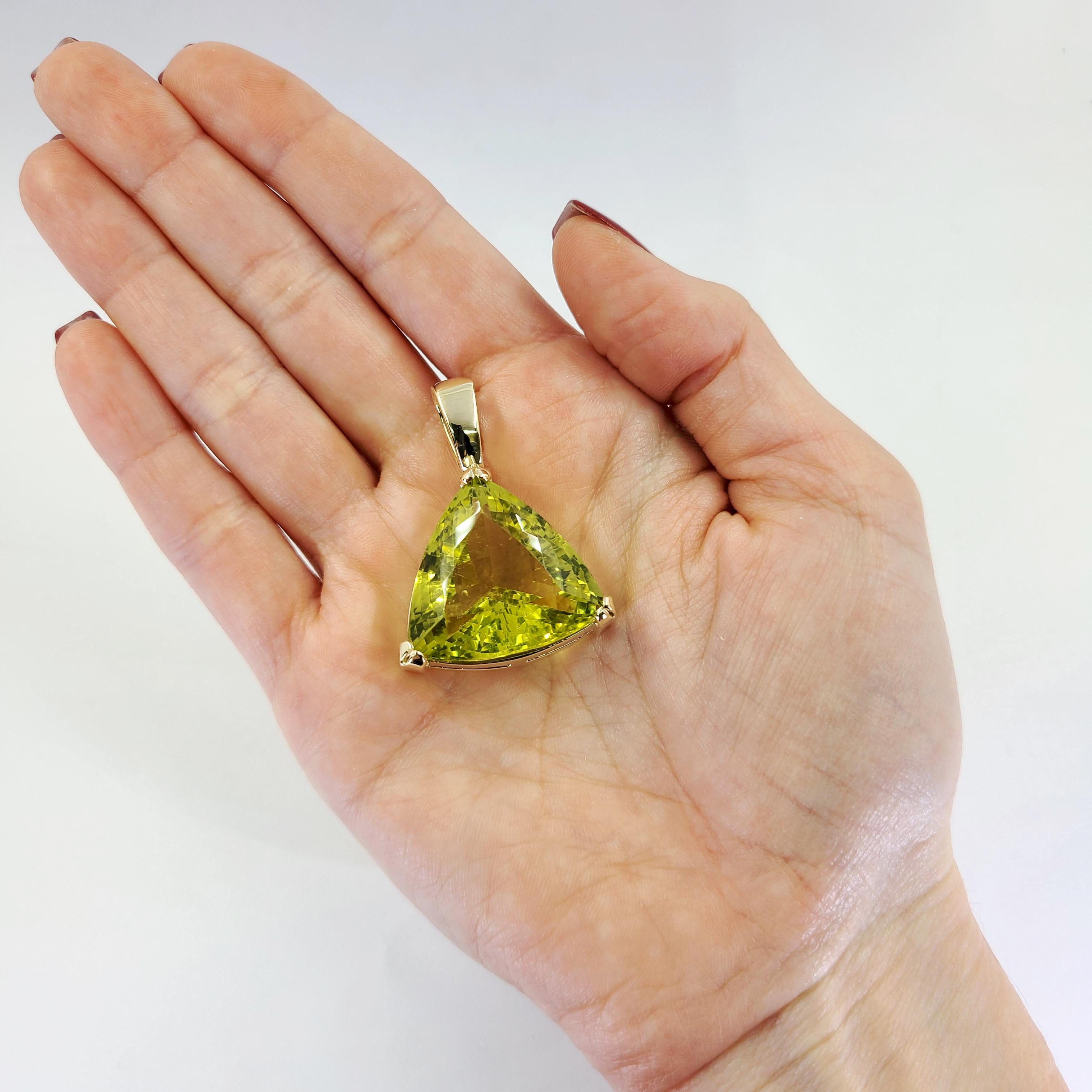 14 Karat Yellow Gold Triangular-Cut Lemon Citrine Pendant. 1.5 Inches Long. Finished Weight Is 21.1 Grams.