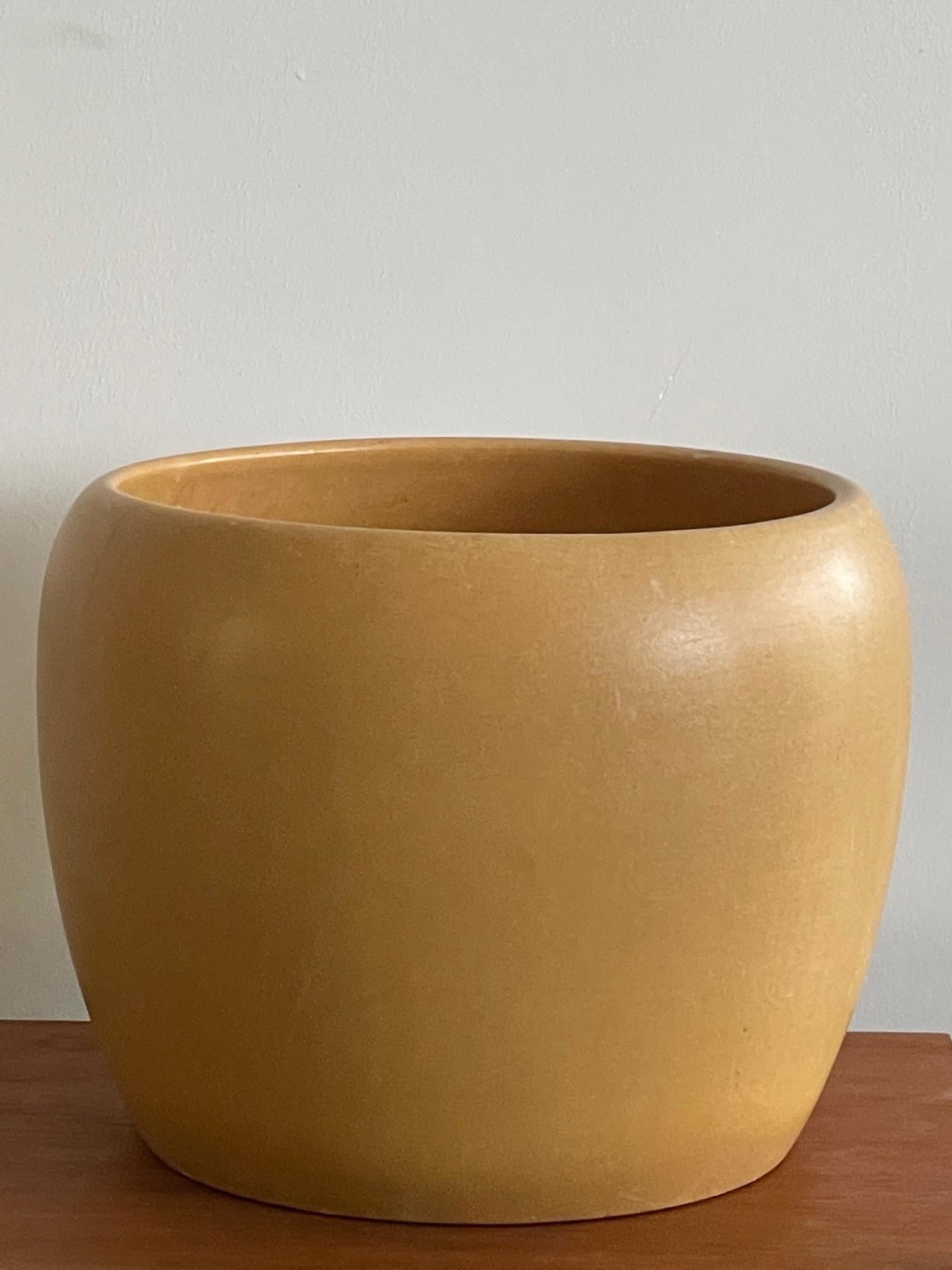 A large scale Gainey of California yellow ochre pot with drilled holes on bottom. Measures 13
