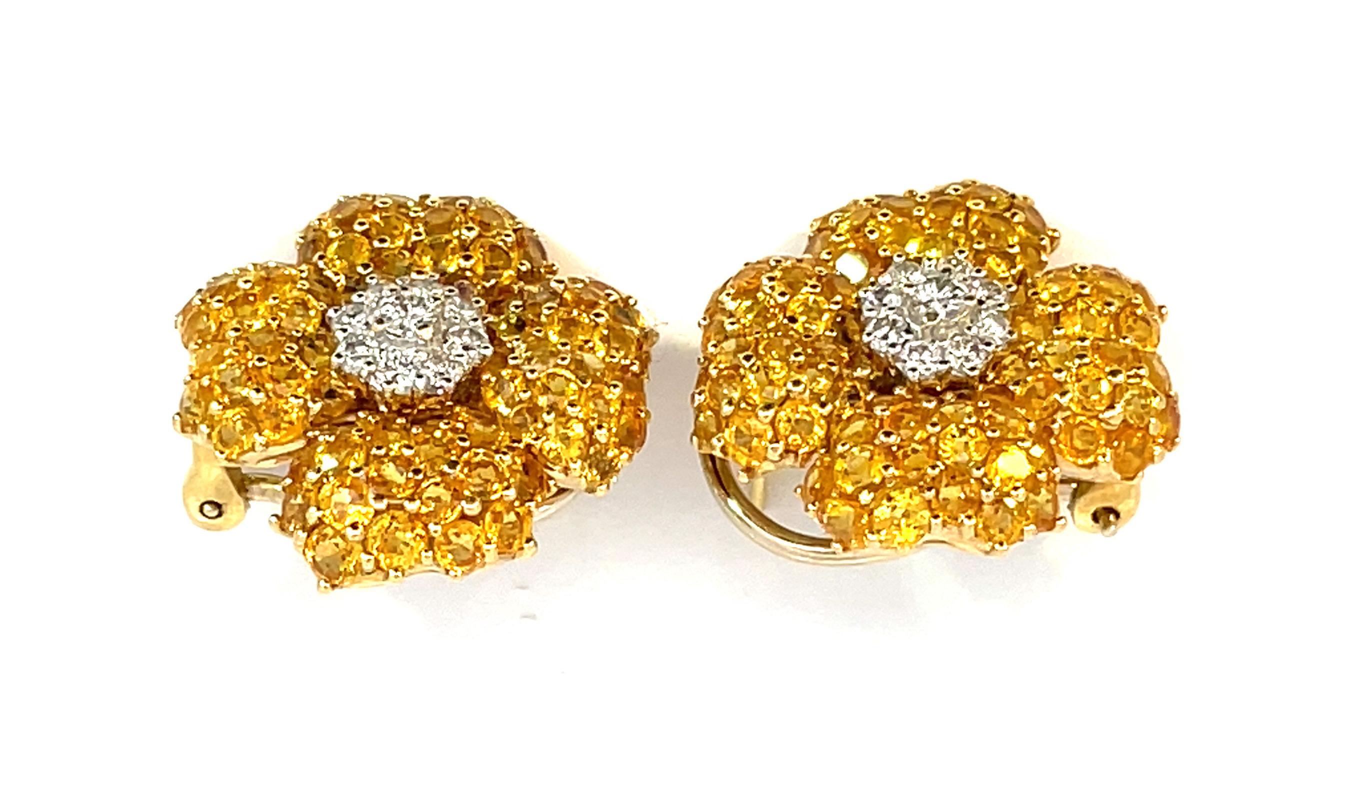 A large pair of natural yellow sapphire and natural diamond earrings set in yellow and white gold with a beautiful honeycomb à jour finishing a post and omega clip system.

18 Brilliant cut natural diamonds weighing 1.02ct total weight, quality