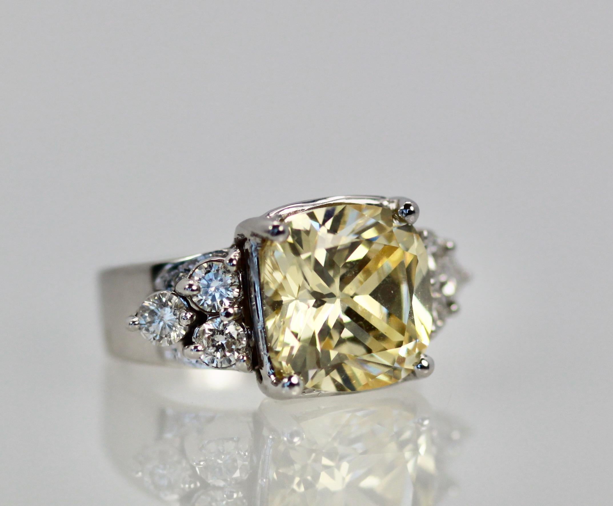 This large Yellow Sapphire is approximately 13 carats and has 3 Diamonds on each side as accents with each Diamond totally 0.15 carats each, total of 6 stones tcw 0.90 carats for a total of 13.90 carats.  This ring is made in 18k white gold and is