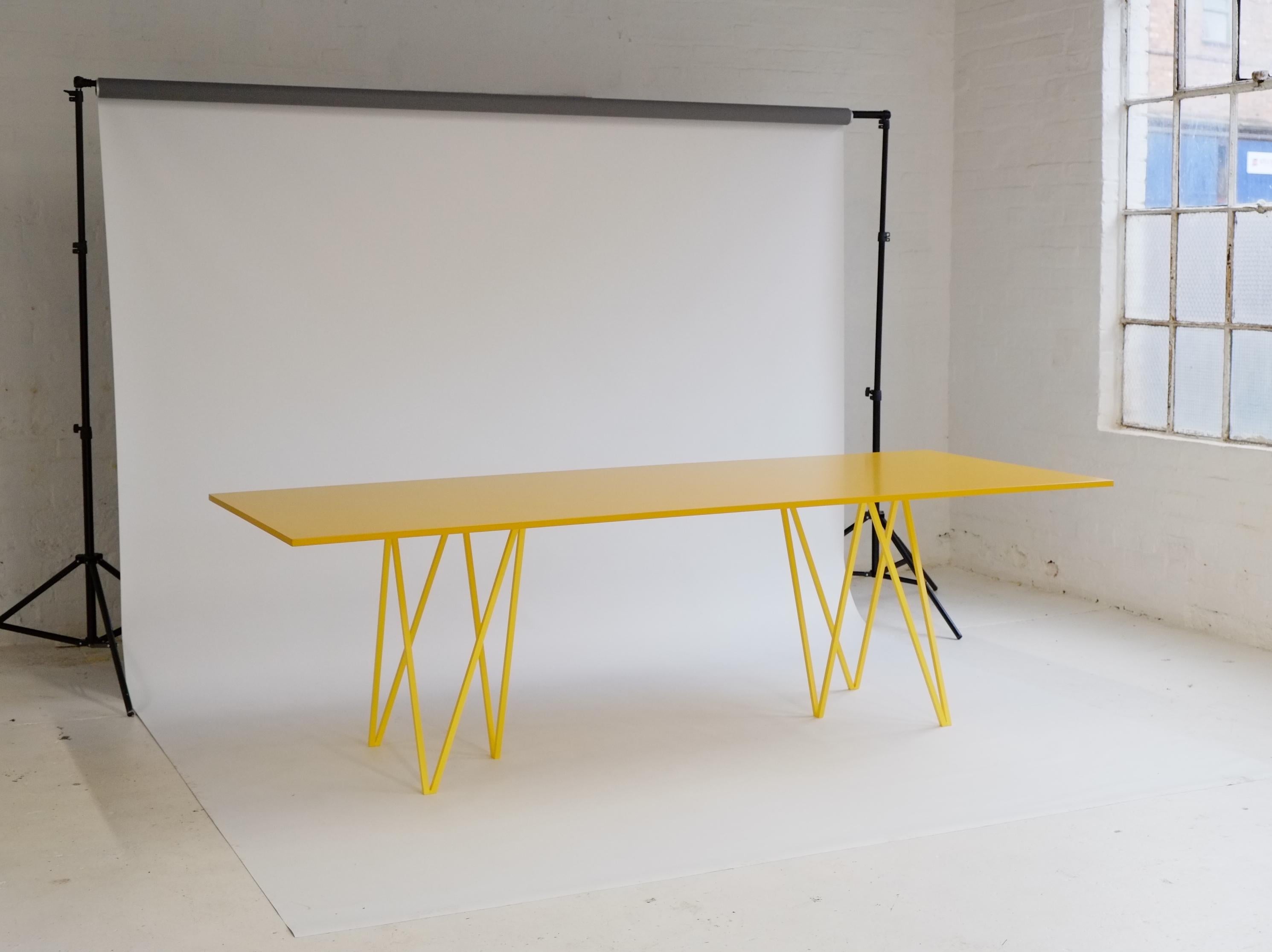 The ZigZag dining table is a bold and elegant statement piece.

This ZigZag dining table is made with bright yellow powder coated, solid steel zigzag legs with a contrasting yellow lacquered table top. The table top is finished with a food safe