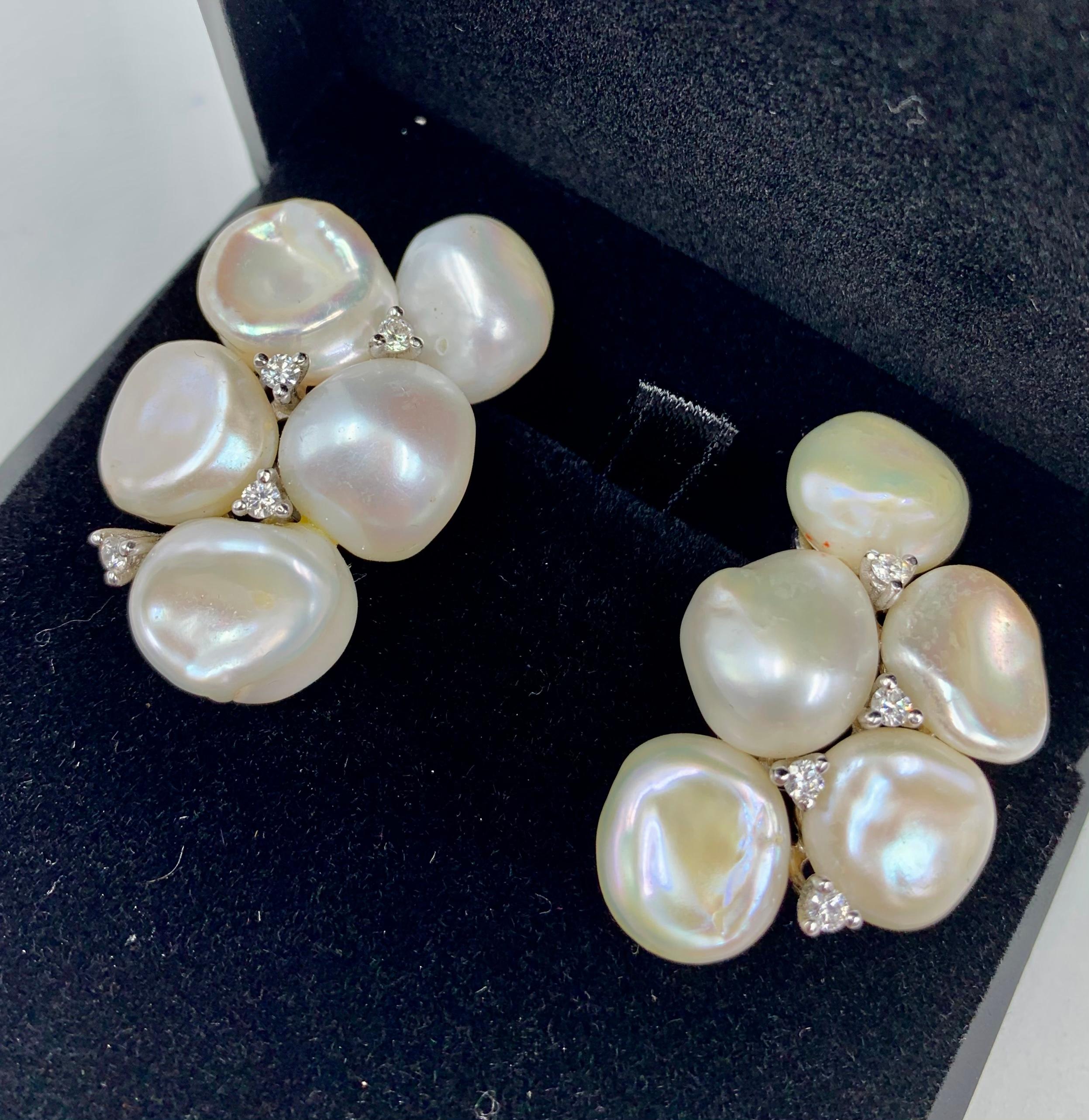 Beautiful lustrous creamy white Keshi pearl and diamond earrings signed Yvel, each composed of five Keshi pearls measuring approximately 12mm each with diamond accents set in great quality 18K white gold setting.
Excellent condition
Pearls with very